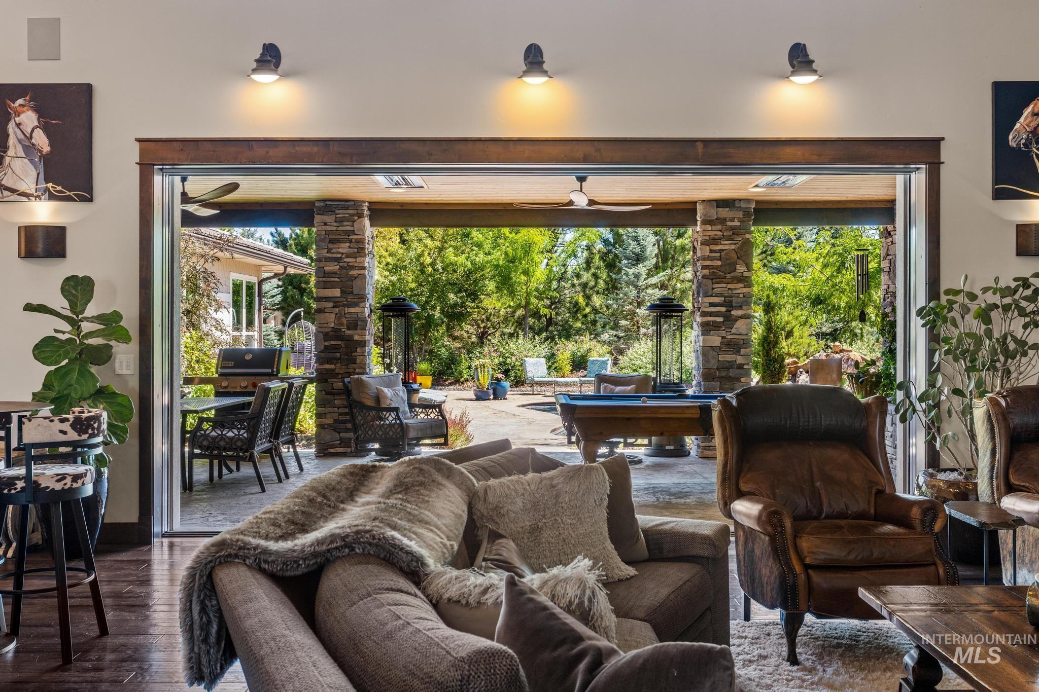 Living room featuring wood finished floors, billiards, and a ceiling fan