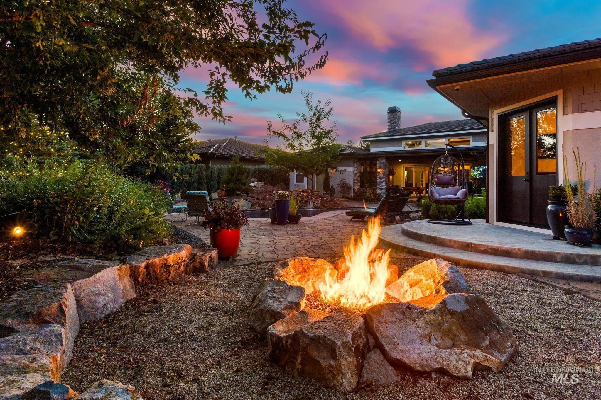 View of yard featuring a fire pit, french doors, and a patio