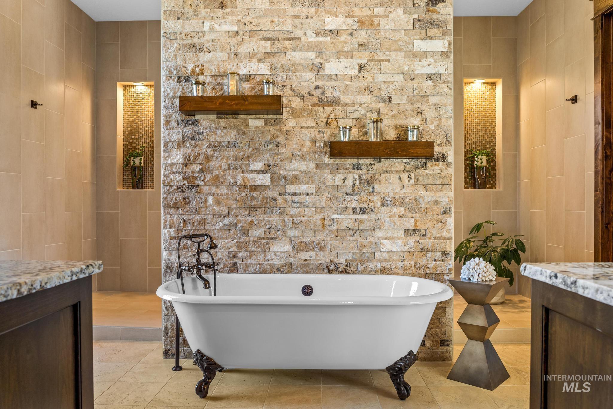 Bathroom with tile walls, a freestanding bath, tile patterned floors, and vanity