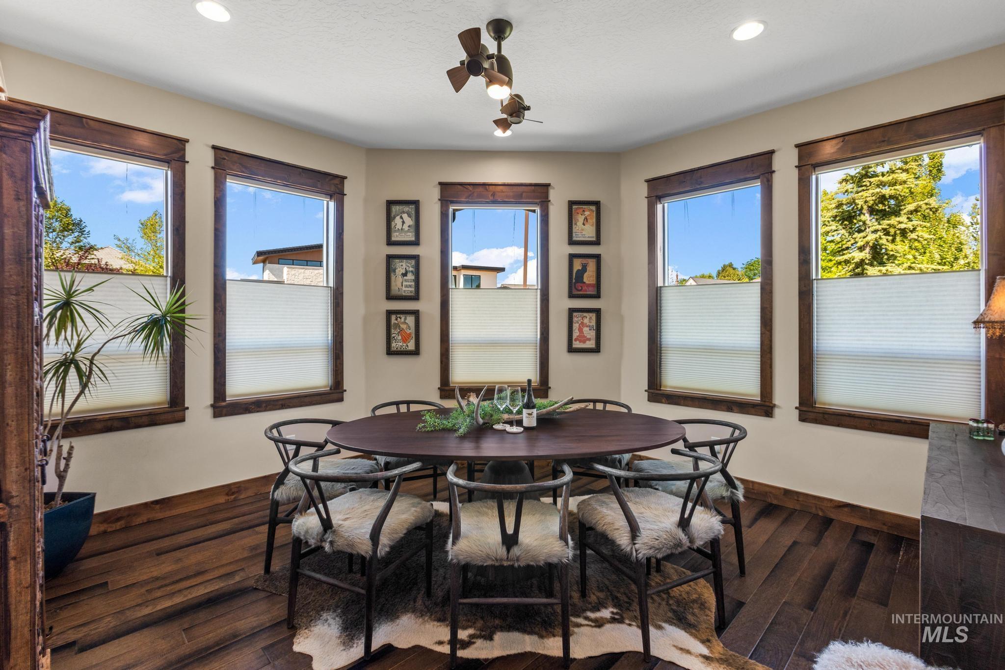 Dining space with wood finished floors and recessed lighting