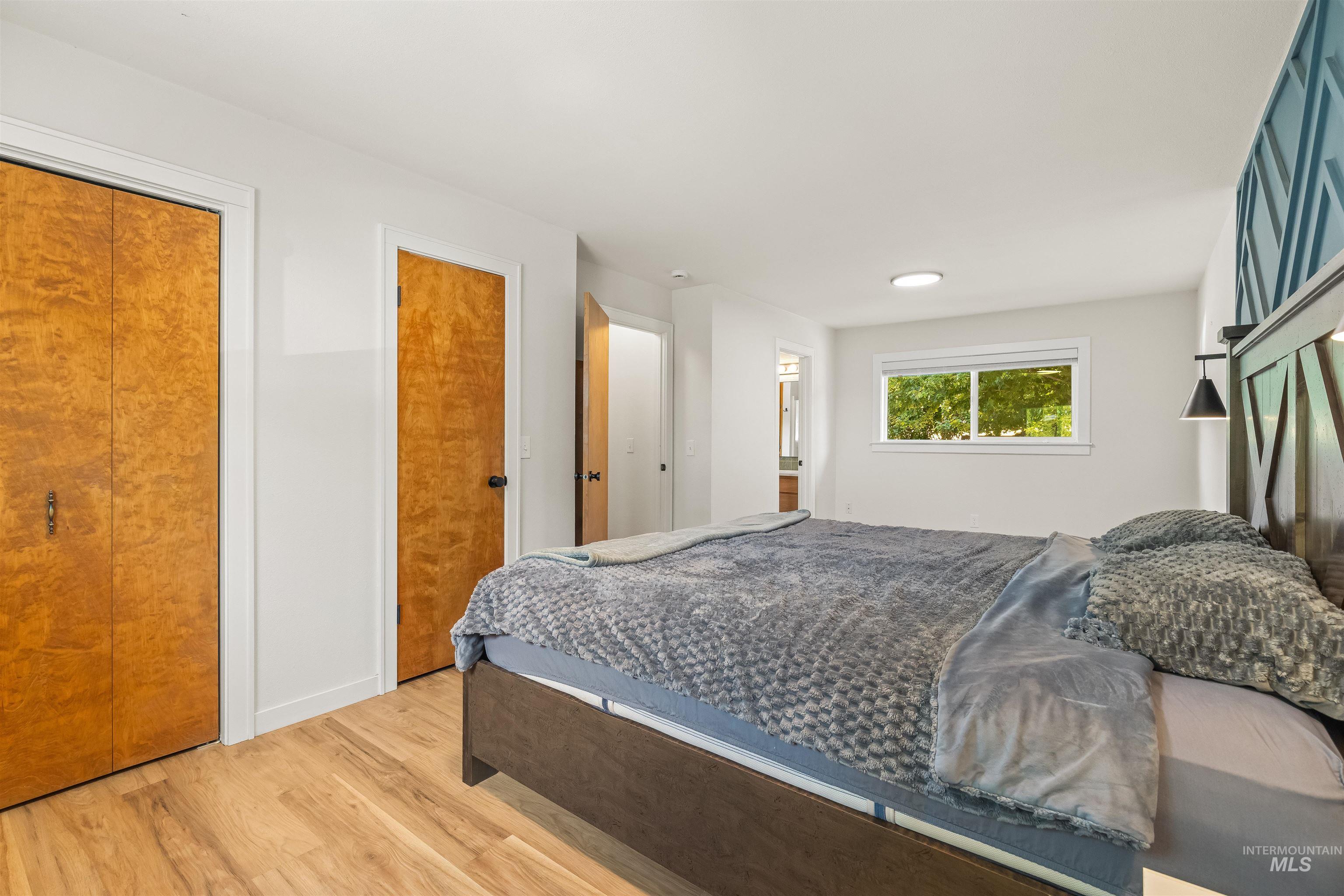 Hardwood-finish flooring extending throughout the room