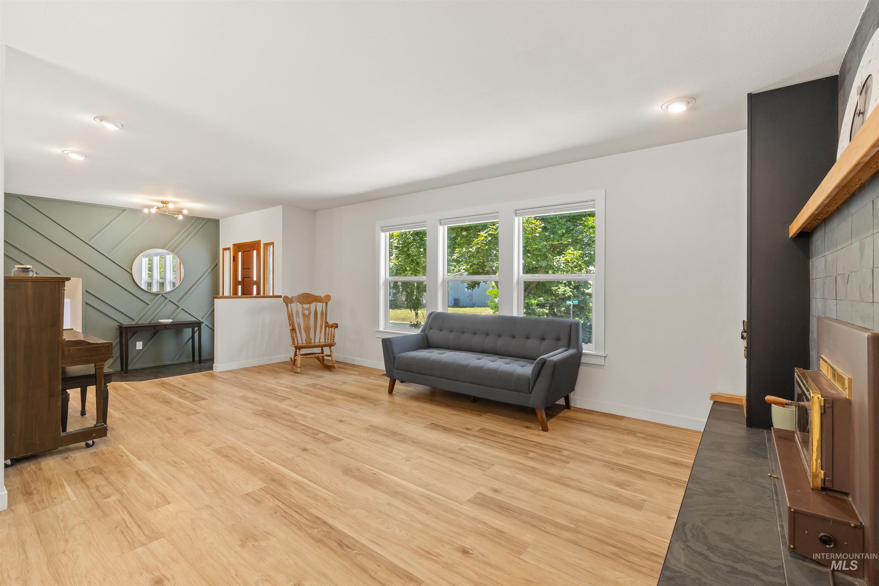Expansive living area featuring light wood-finish flooring and recessed lighting