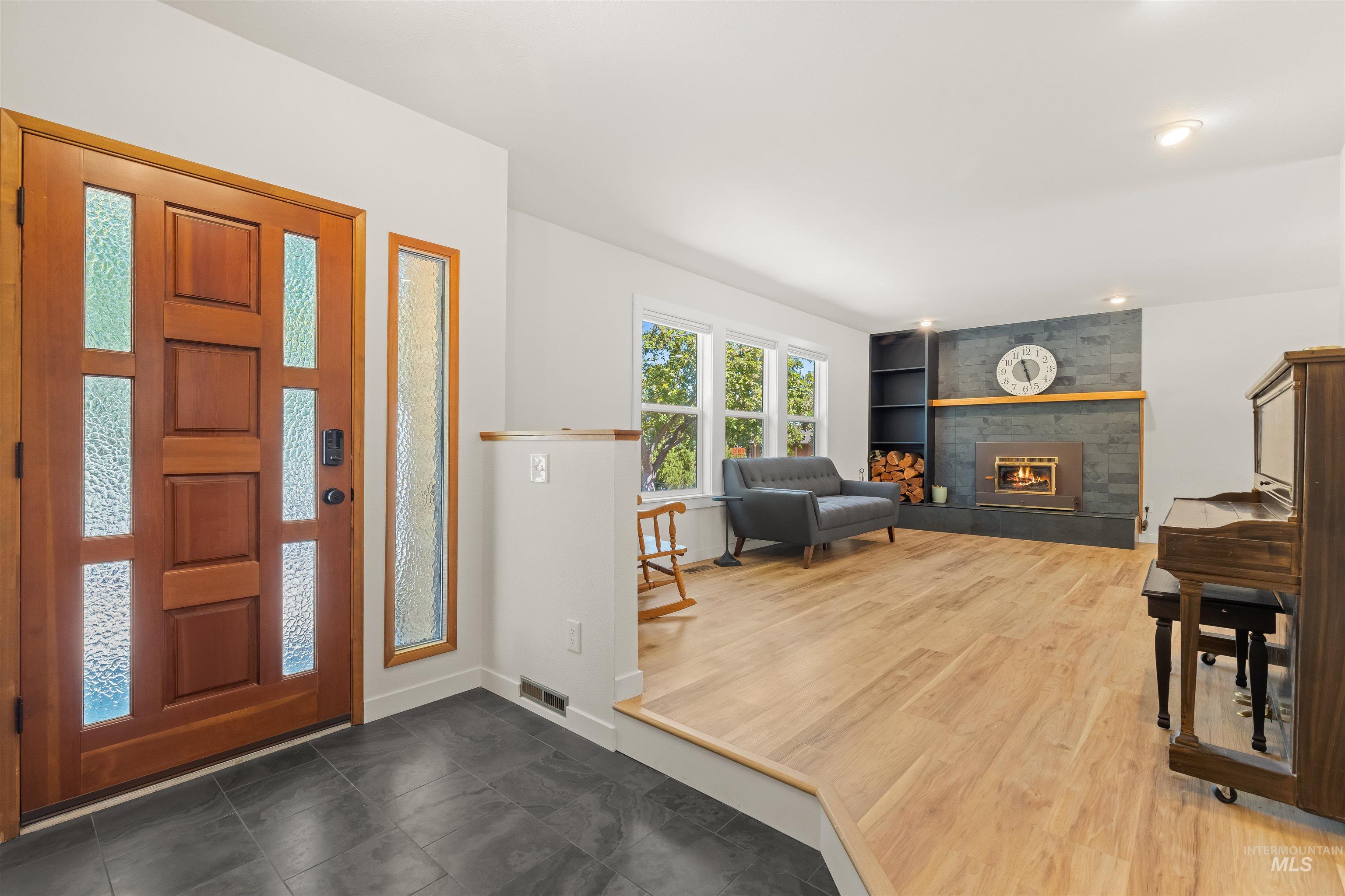 Inviting entryway with rich wood door and frosted glass panels