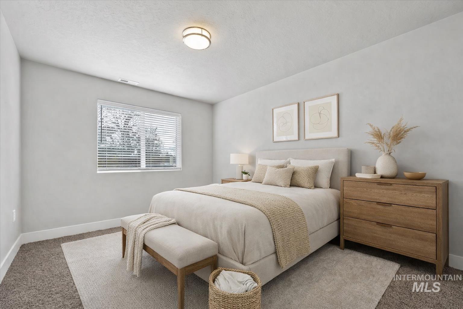 Bedroom featuring carpet floors and a textured ceiling
