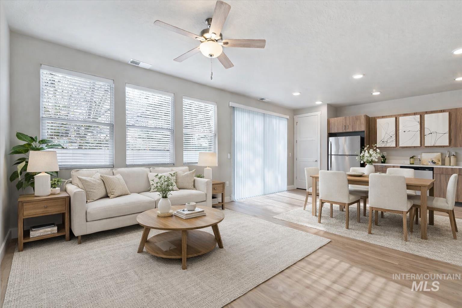 Living room with light wood-style flooring, a ceiling fan, and recessed lighting