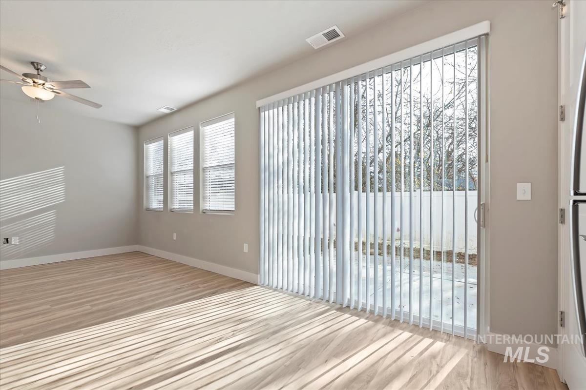 Unfurnished room featuring light wood finished floors and a ceiling fan
