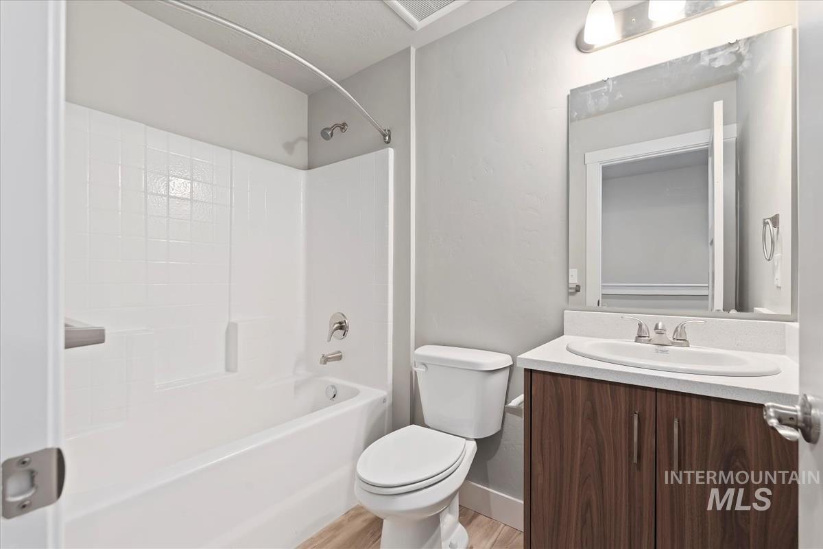 Full bathroom featuring shower / washtub combination, vanity, and light wood finished floors