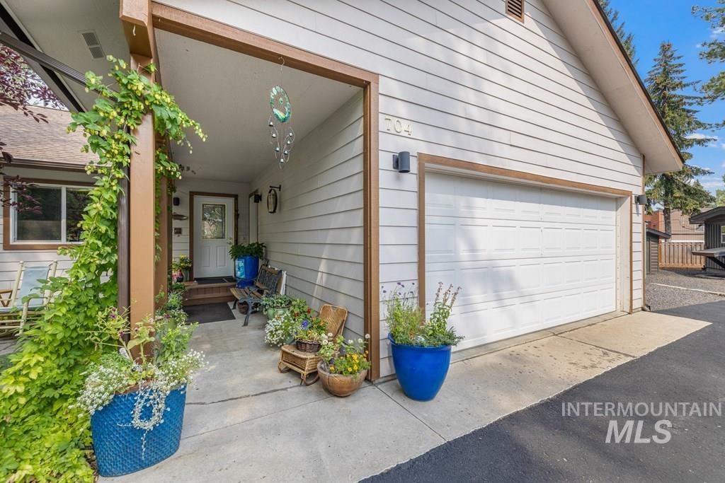 Doorway to property with a garage