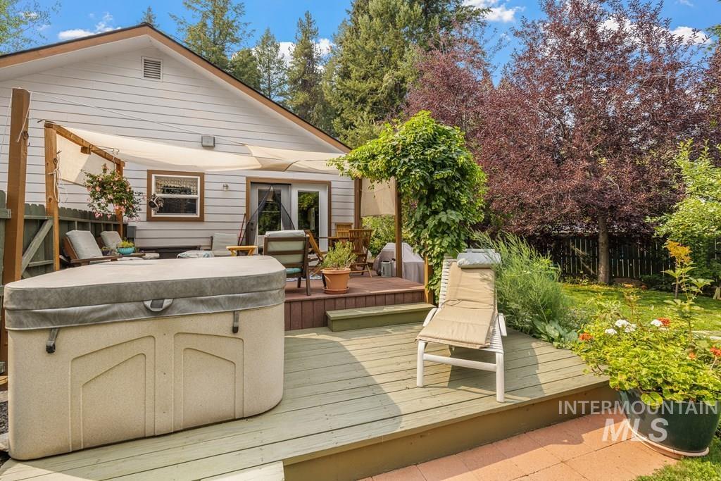 The backyard is fenced and looks over beautiful fruit trees and perennial beds.