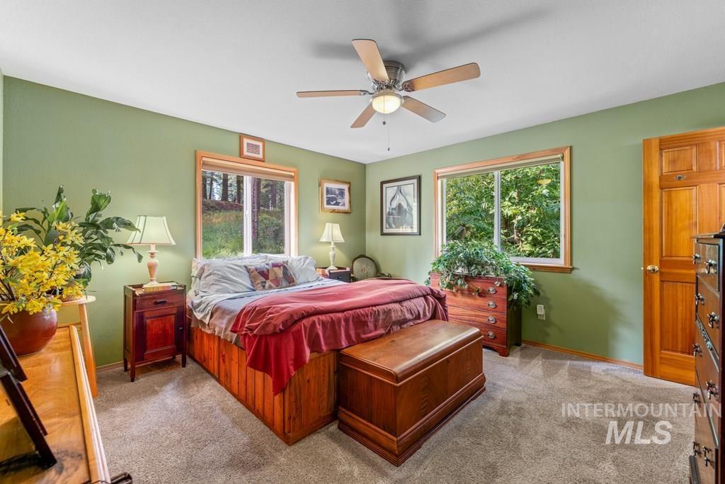 Bedroom with light carpet and ceiling fan