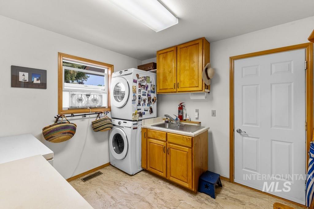 Additional storage, a sink and full size washer and dryer; the door leads to the two car garage.