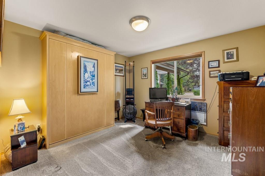 This guest room is being used as an office, but has a closet in case you want to use it as a bedroom.