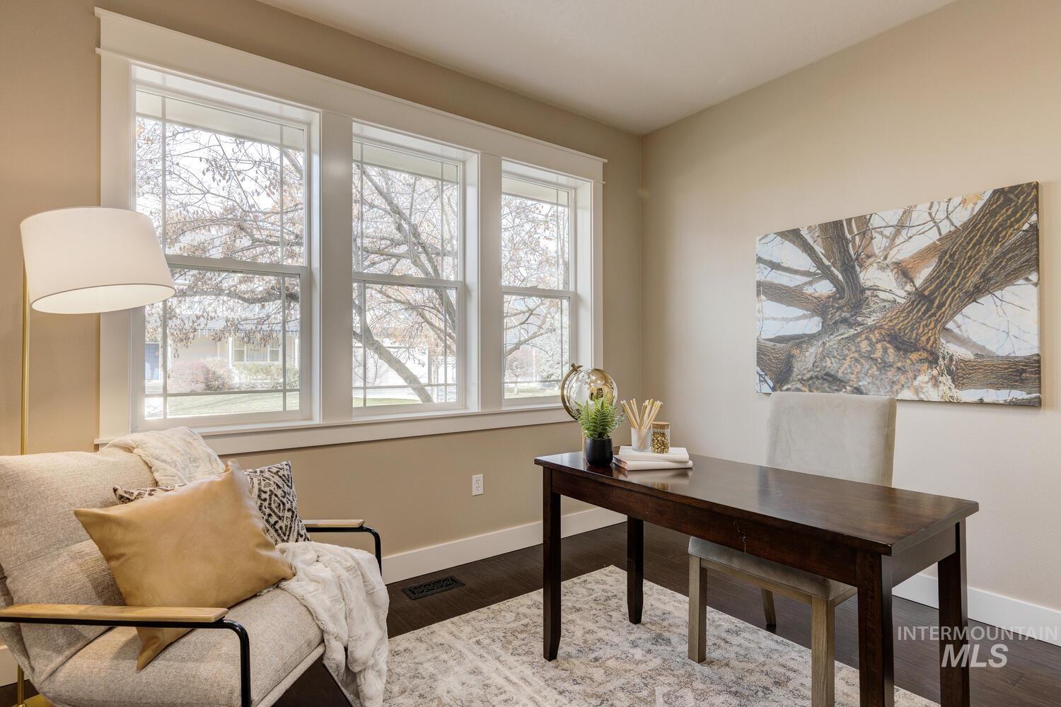 Office area with baseboards and wood finished floors