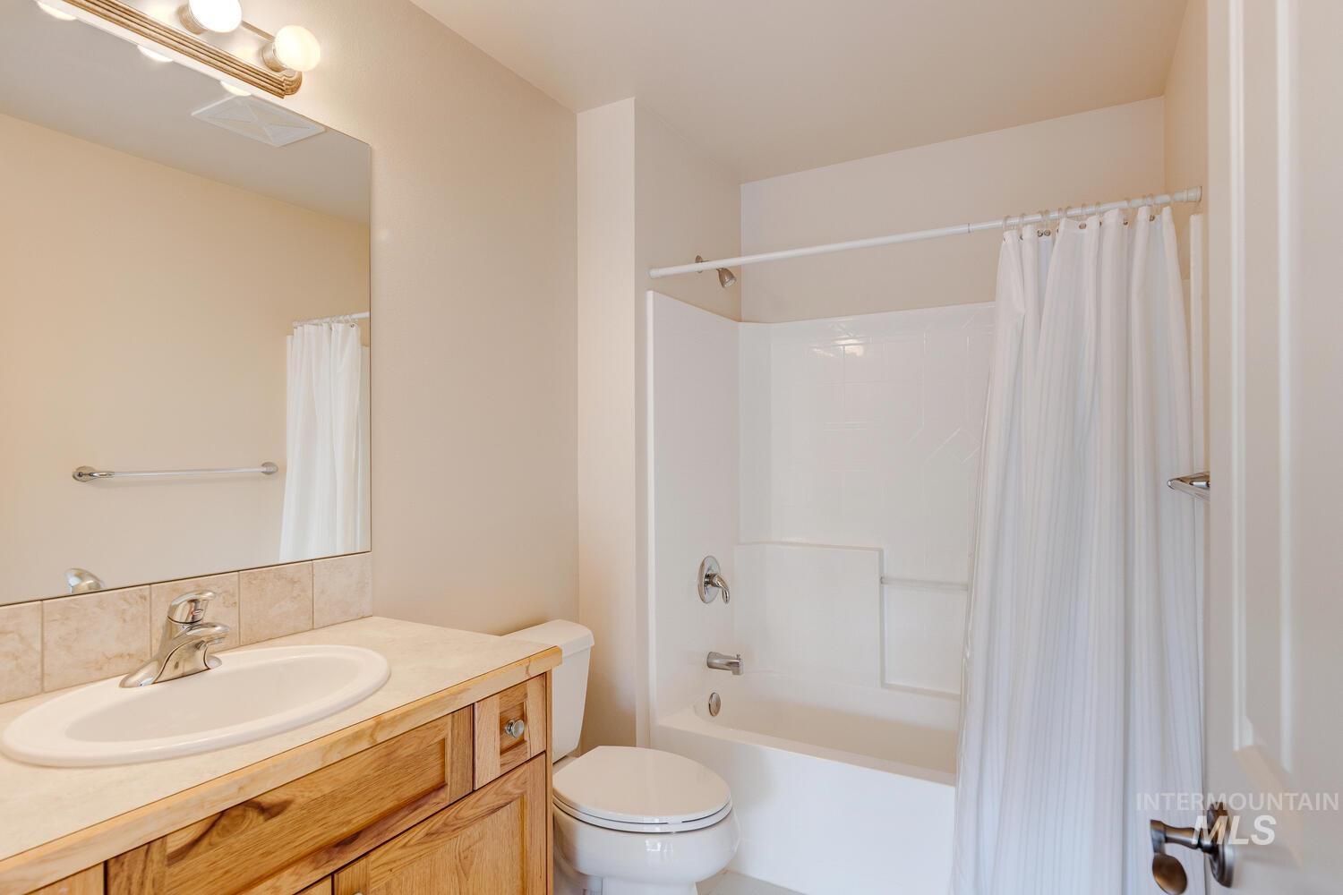 Bathroom featuring vanity and shower / bath combo