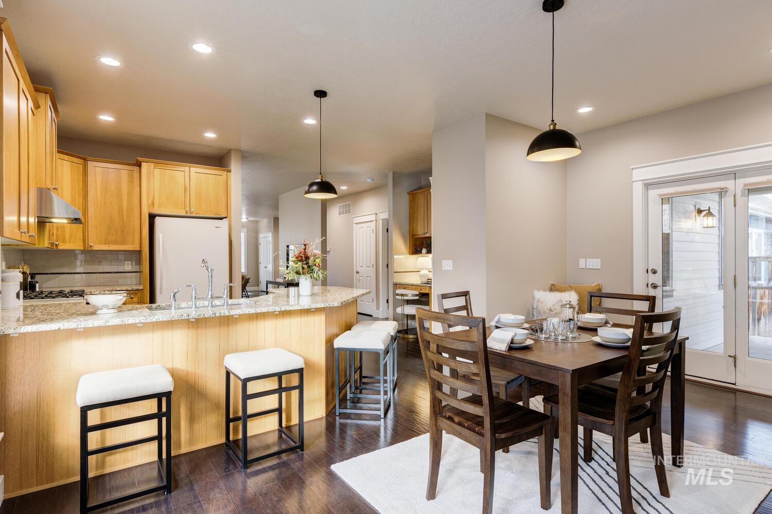 Dining space featuring dark wood-type flooring and recessed lighting