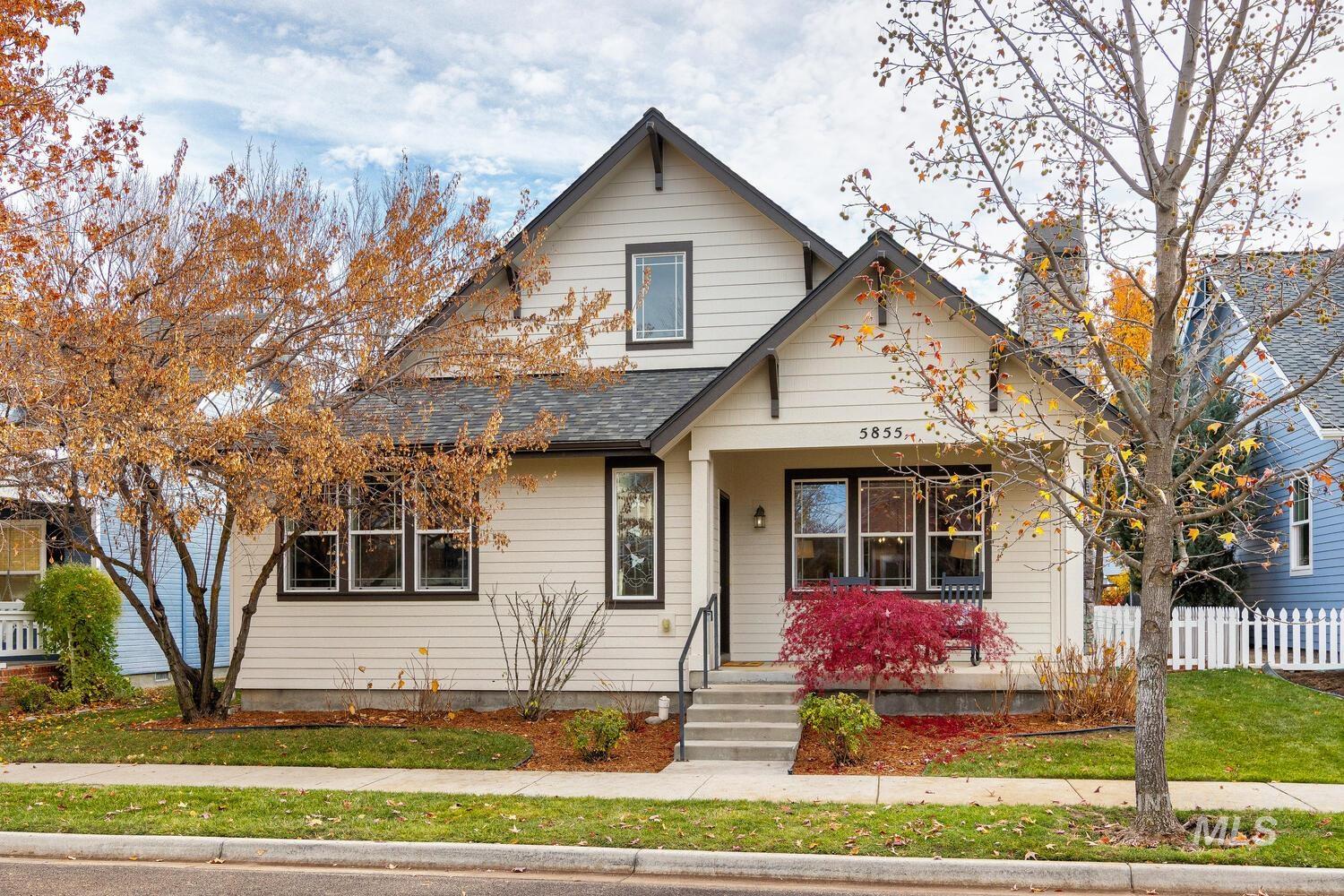 View of front facade featuring a shingled roof and covered porch