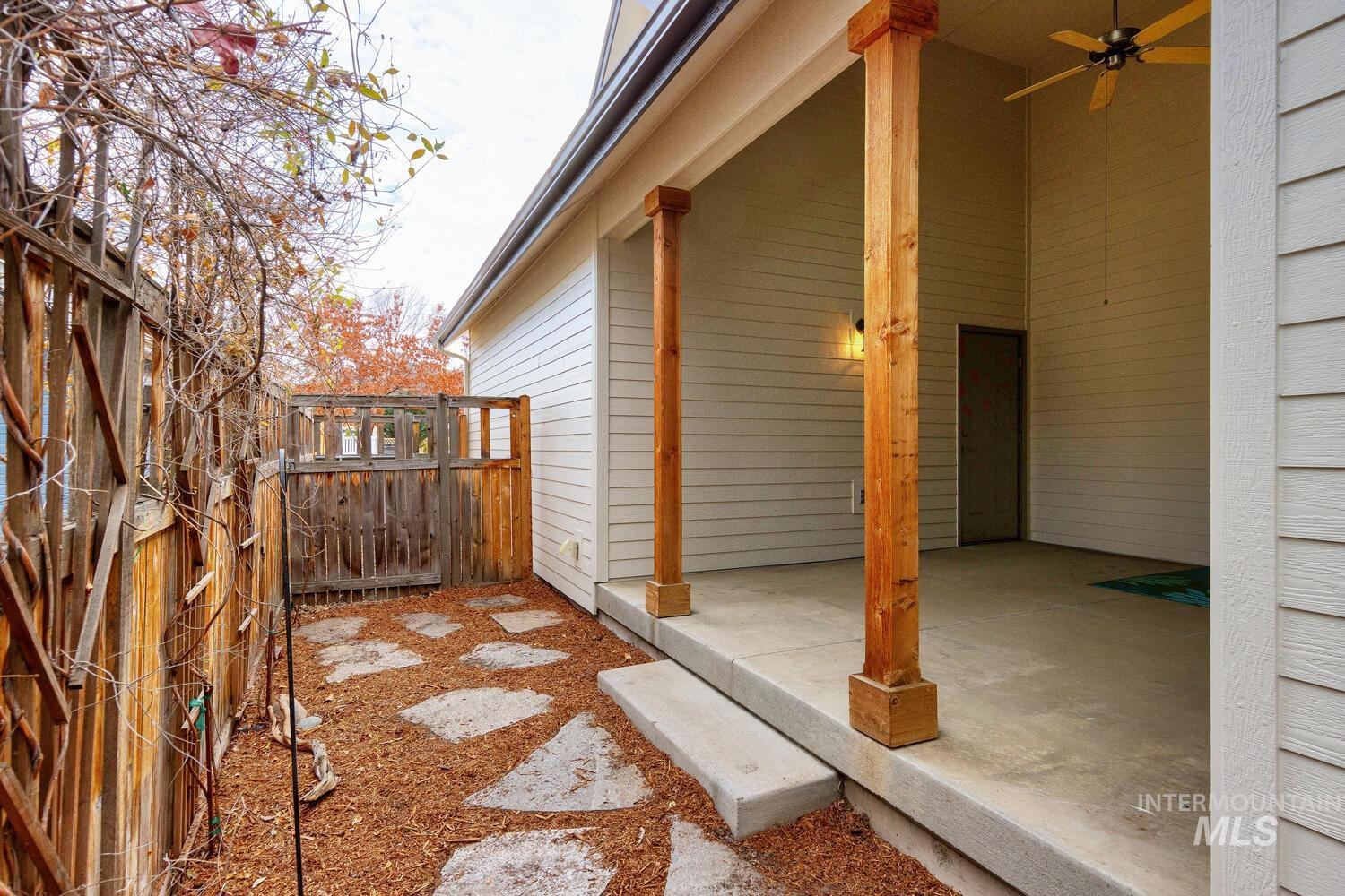 View of home's exterior with a ceiling fan and a patio area