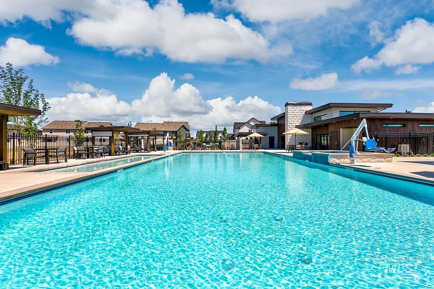 Community pool featuring a patio area and a residential view