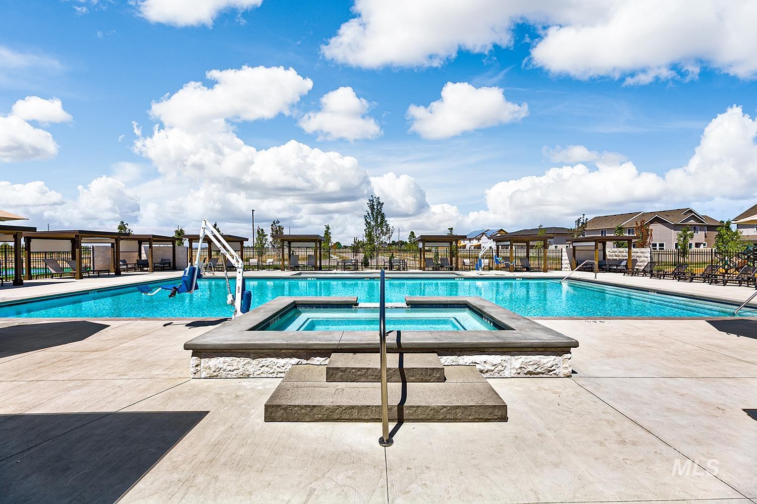 View of pool featuring a patio area and a pool with connected hot tub