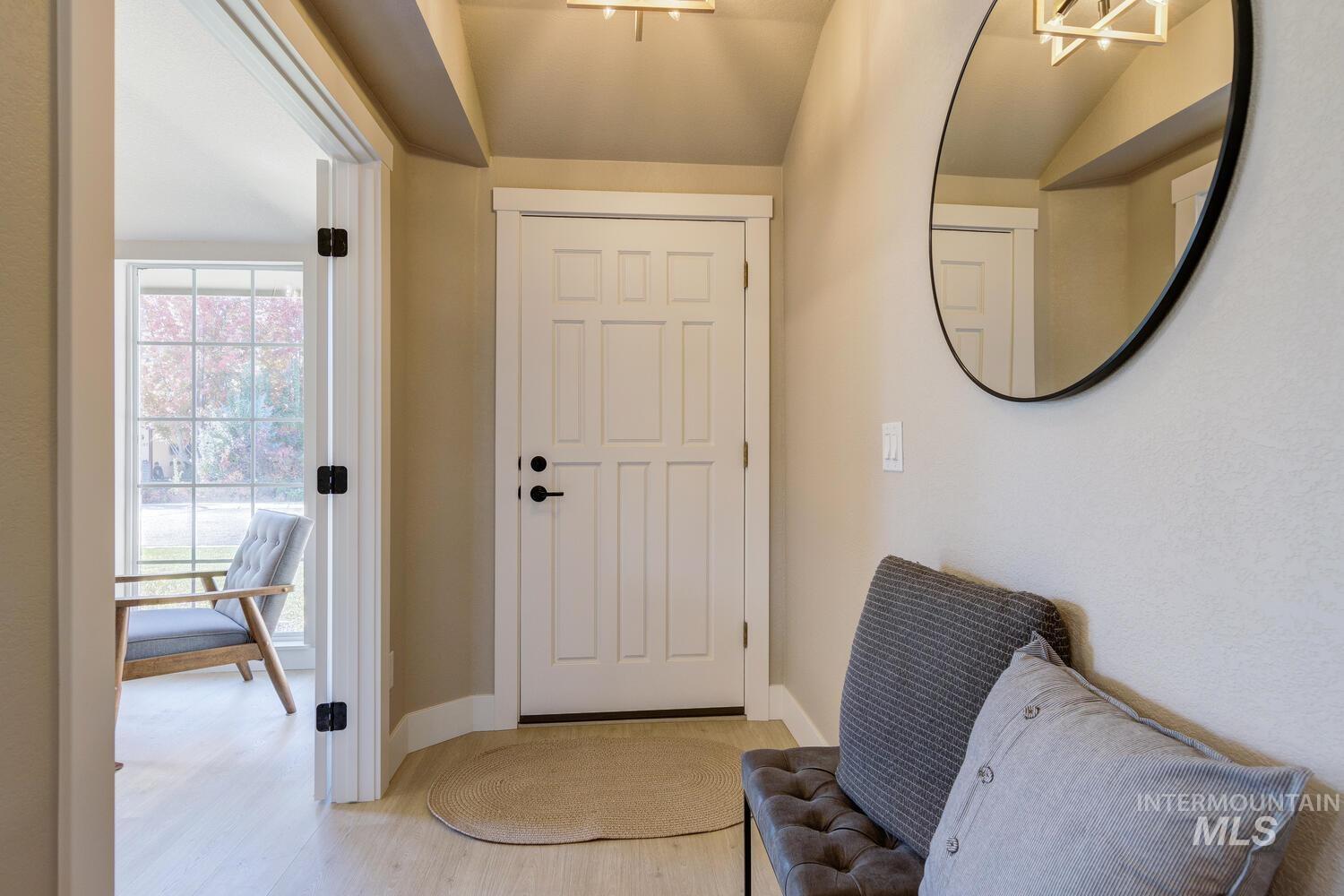 Doorway to outside featuring wood finished floors and baseboards