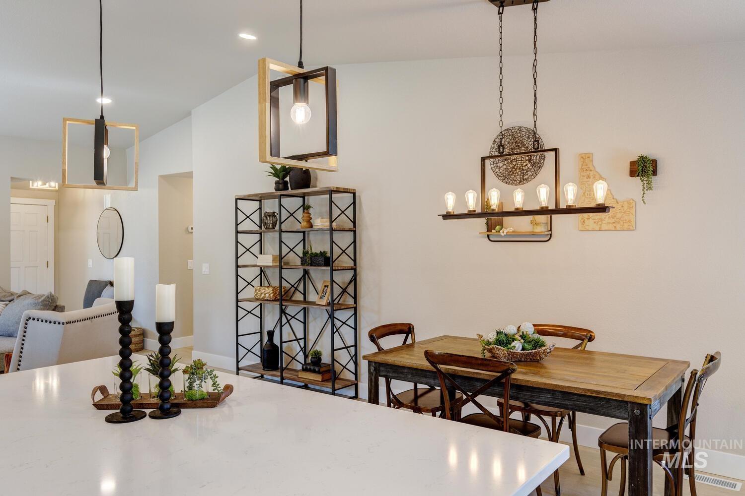 Dining space featuring lofted ceiling, a chandelier, recessed lighting, and wood finished floors