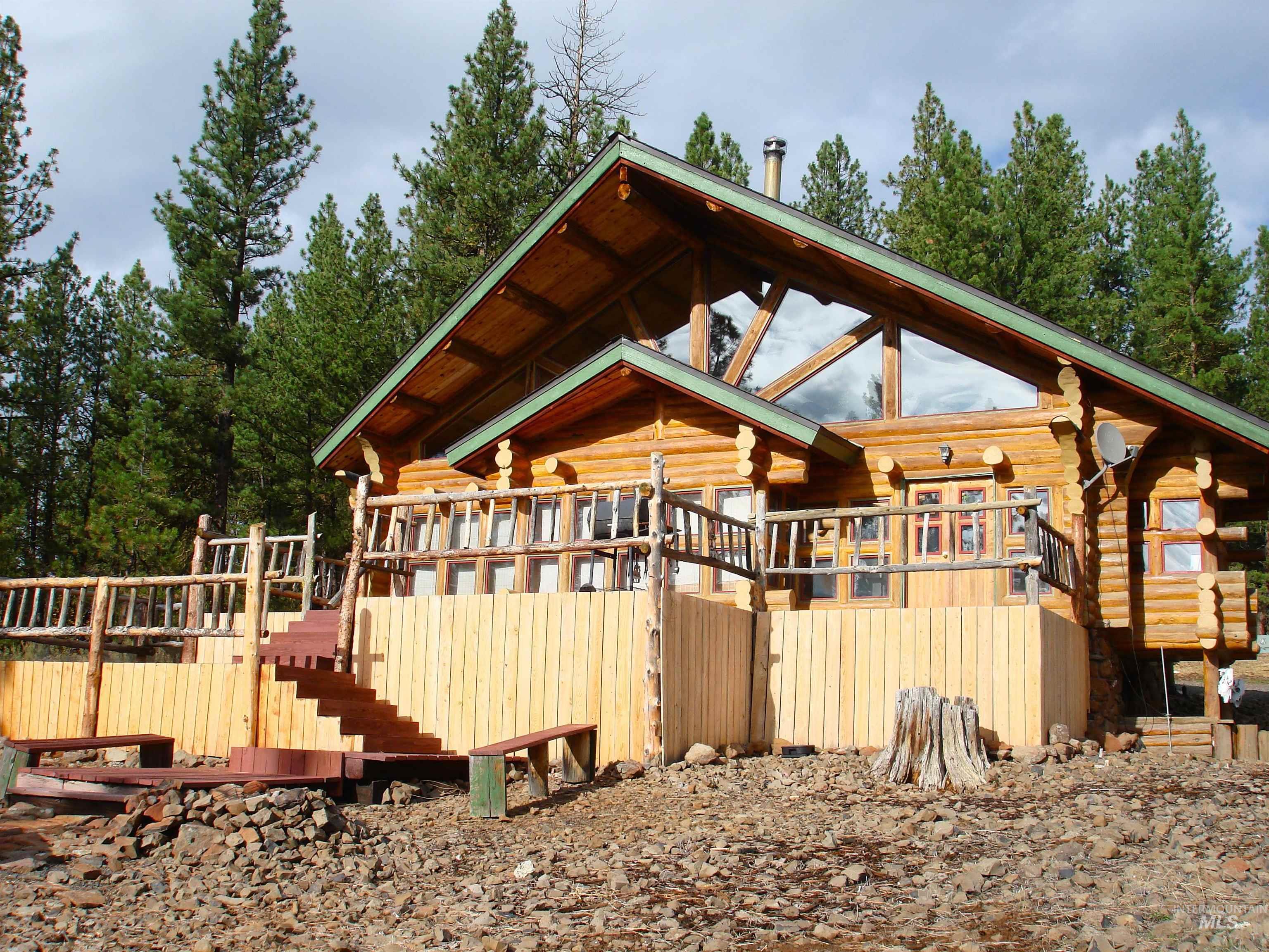 View of property exterior with a wooden deck and log exterior