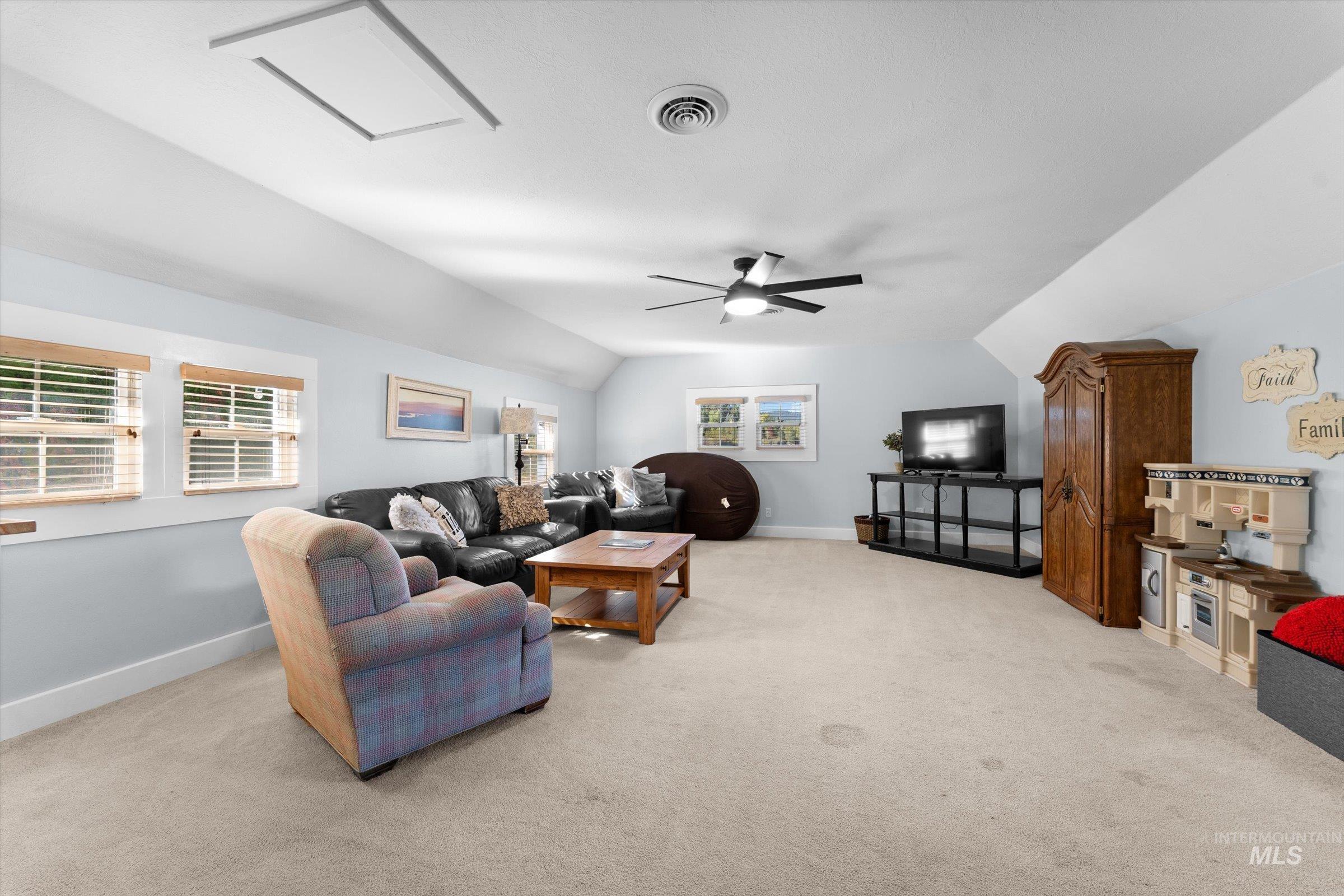 Living room featuring light carpet and lofted ceiling