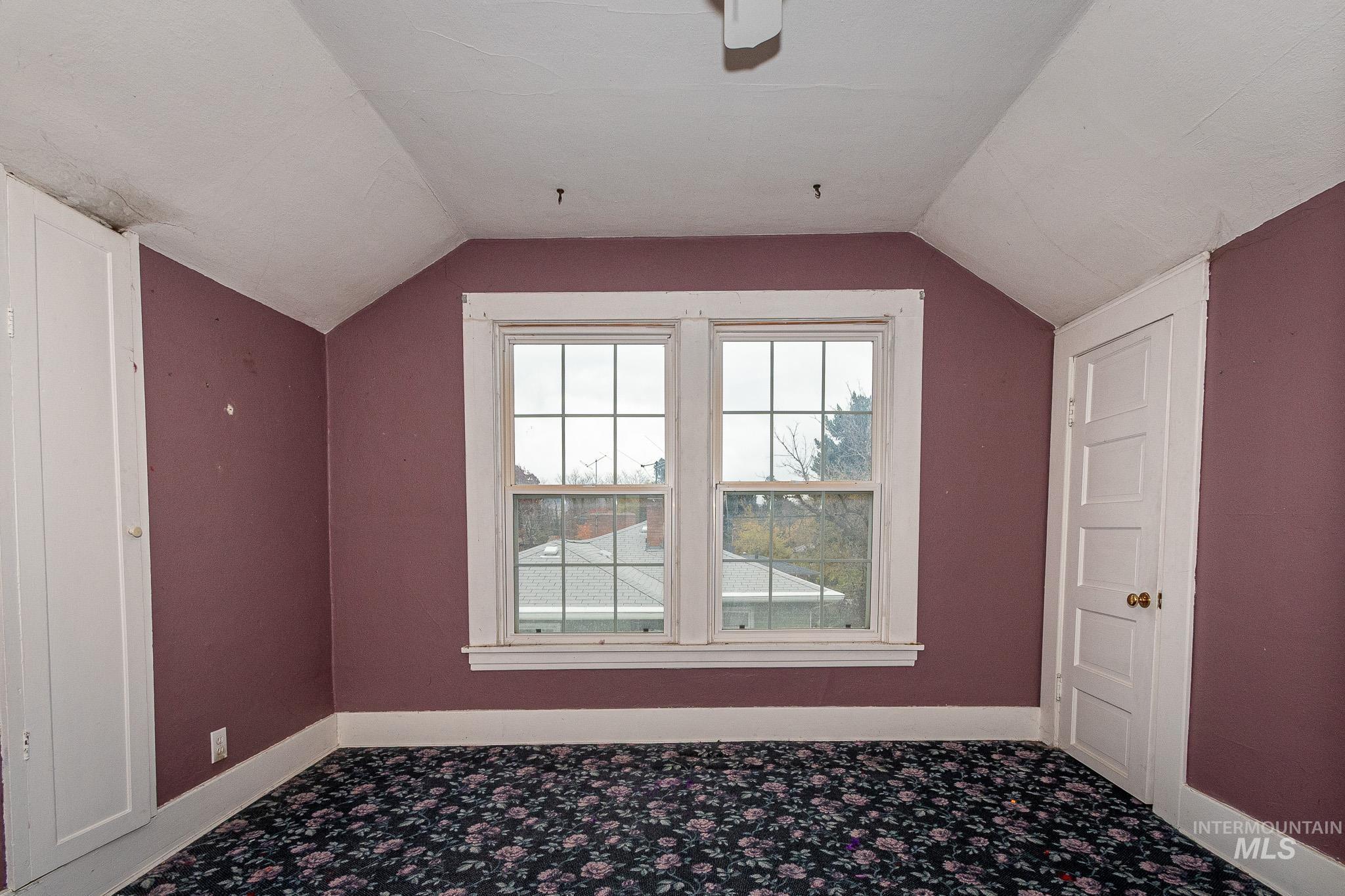 Bonus room featuring vaulted ceiling and baseboards