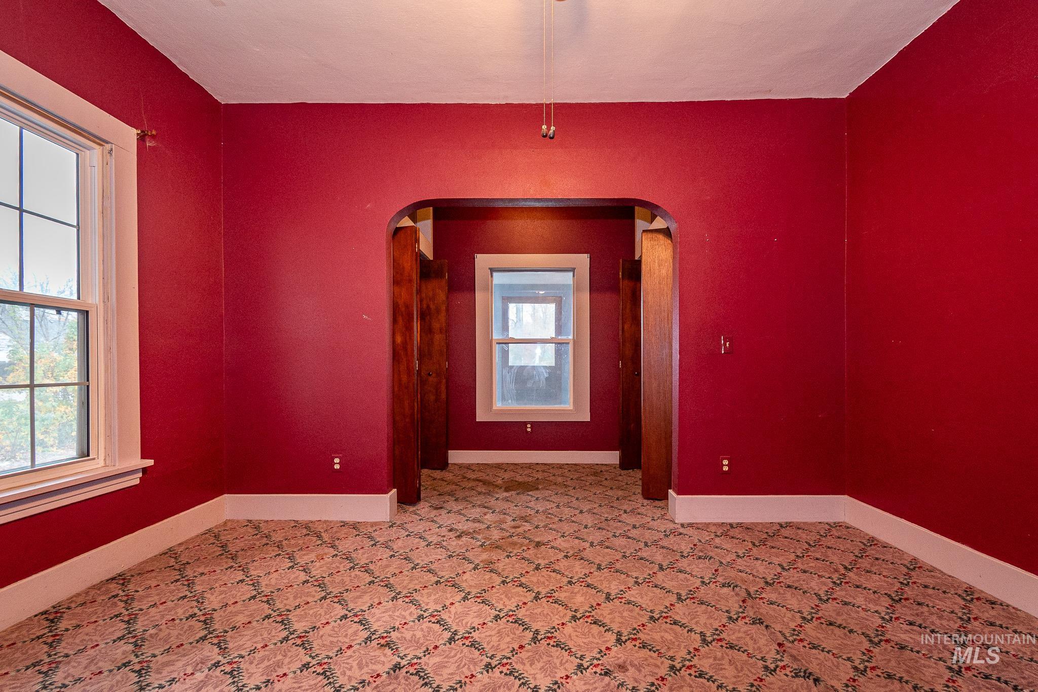 Spare room featuring arched walkways