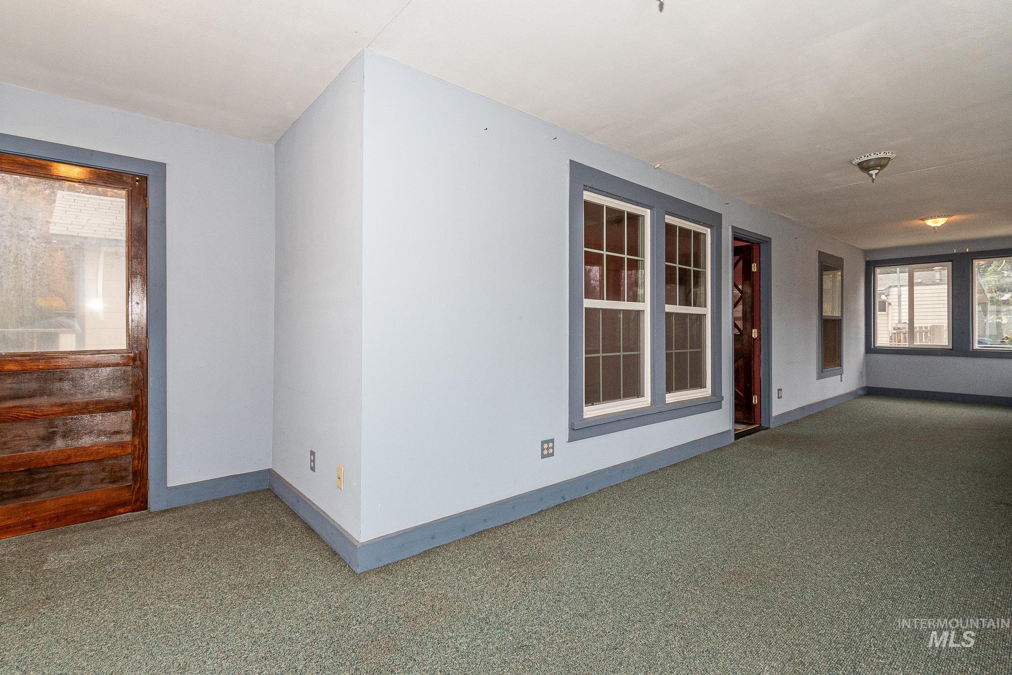 Carpeted empty room with baseboards