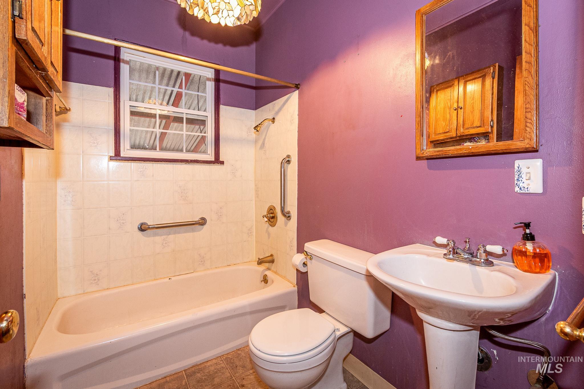 Full bath featuring  shower combination and tile patterned flooring