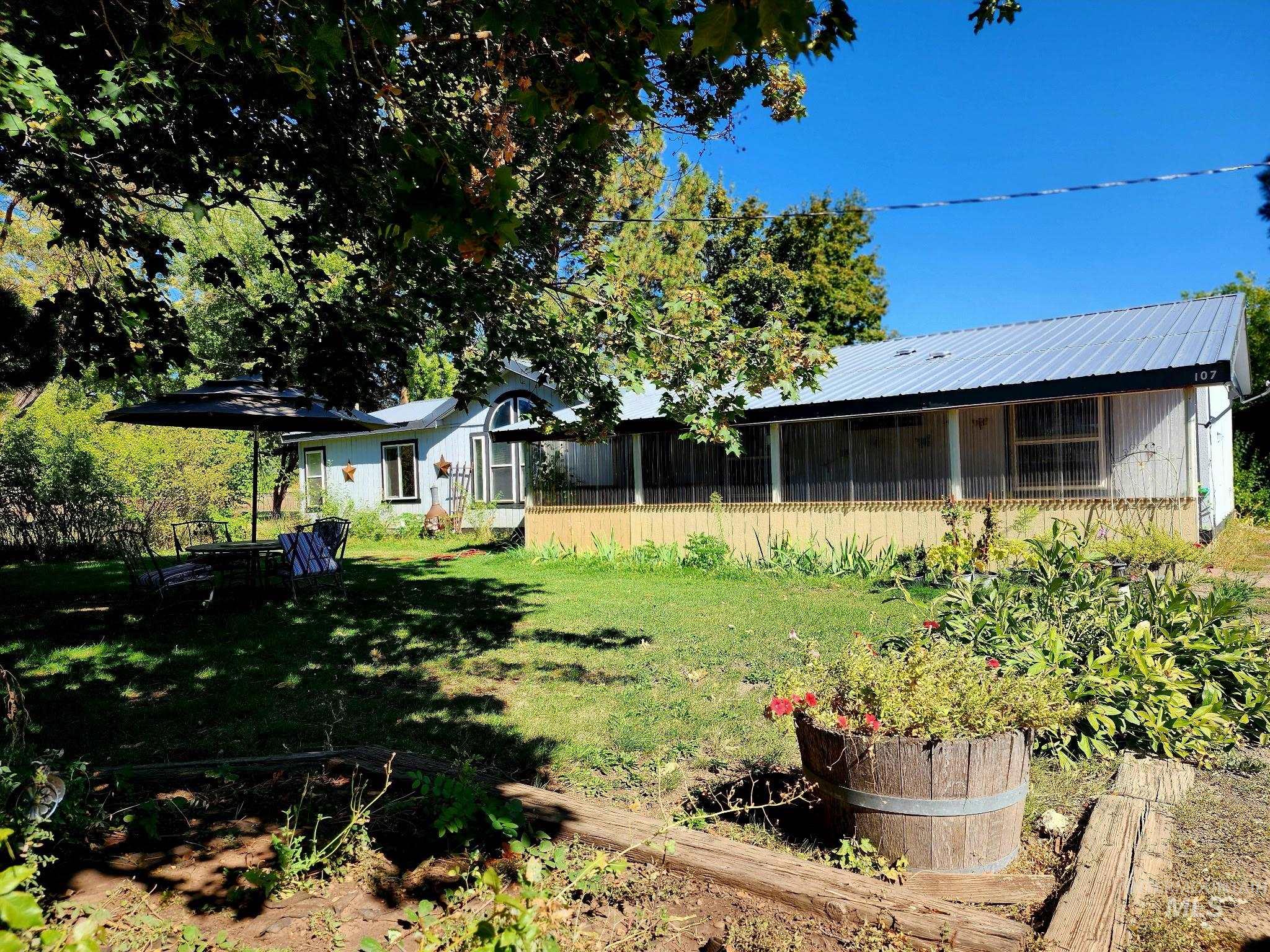 With a shaded patio space, and landscaping, this Idaho property blends comfort, curb appeal, and outdoor living.