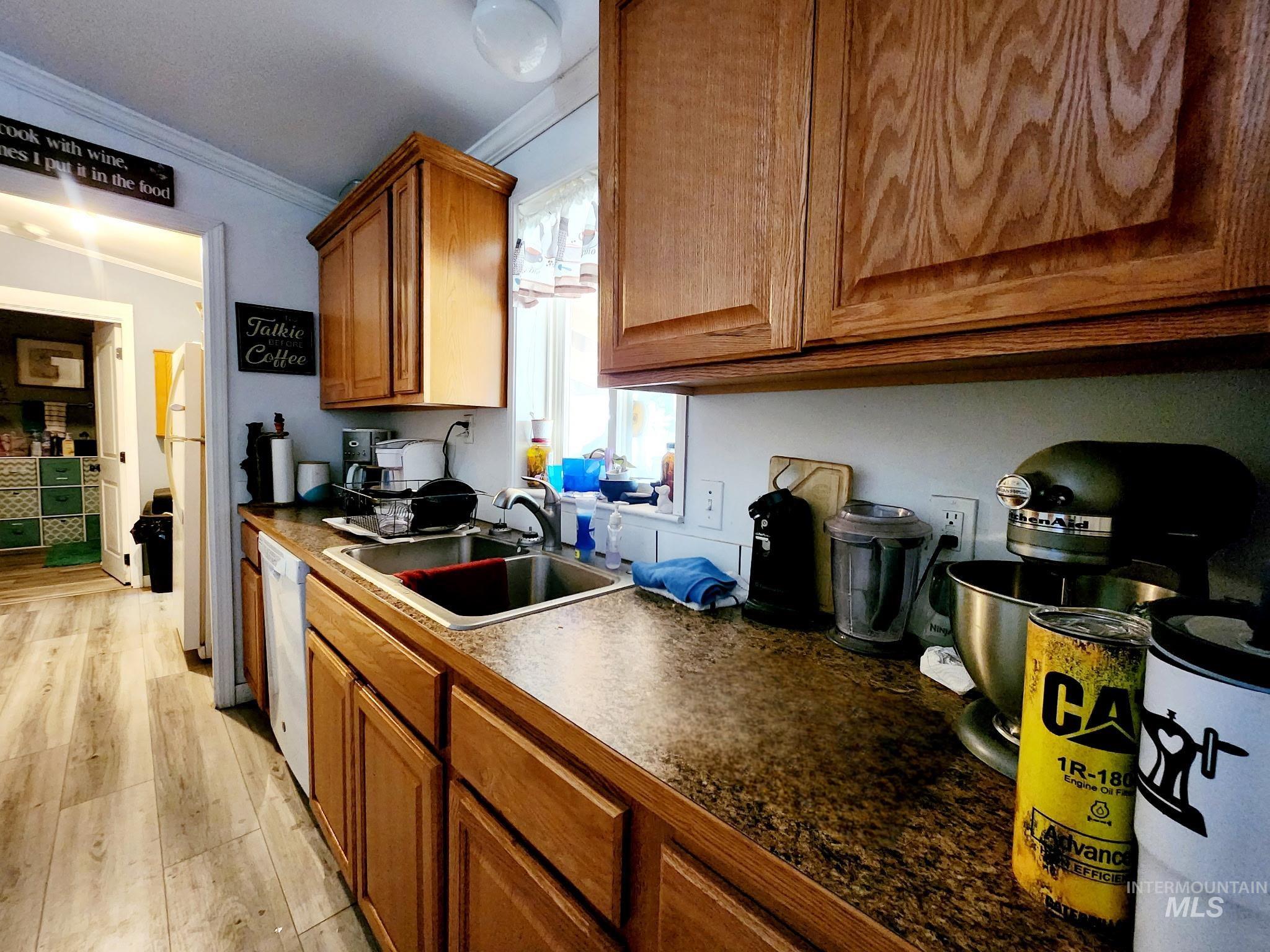 The kitchen provides plenty of storage, abundant prep space, and a window view over the sink, creating a bright and practical hub of the home.