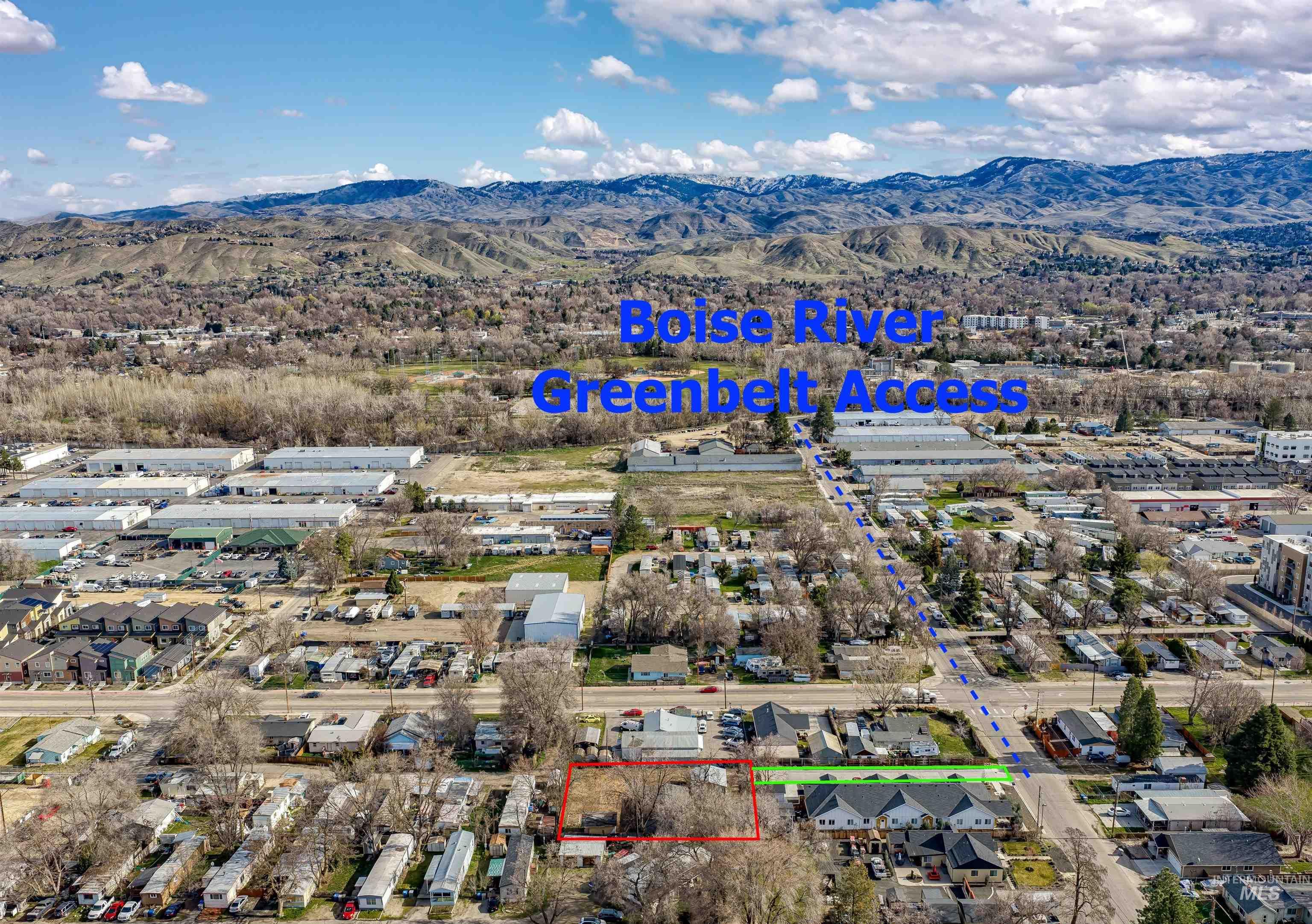 Aerial view of residential area featuring property boundaries highlighted and a mountain backdrop