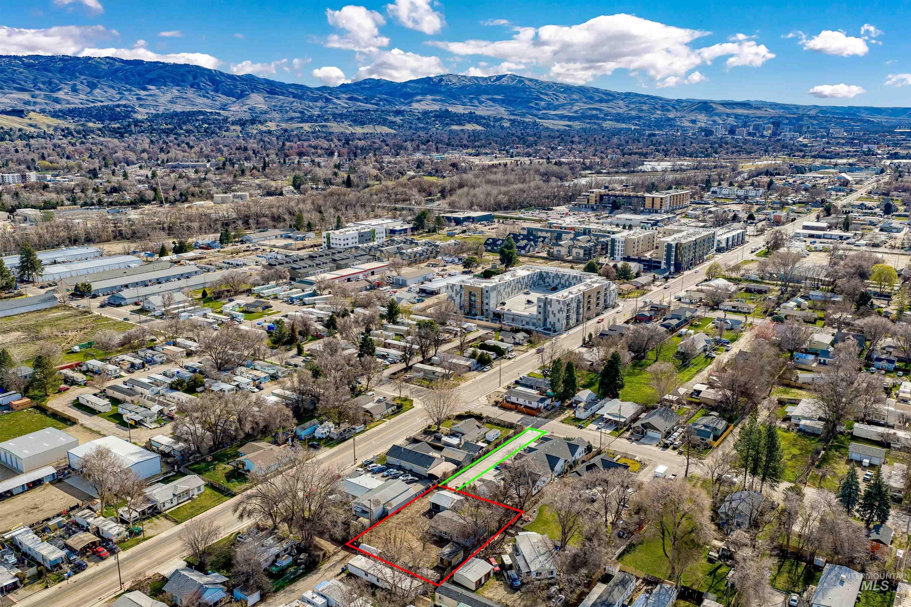 View of urban area with mountains and property parcel outlined