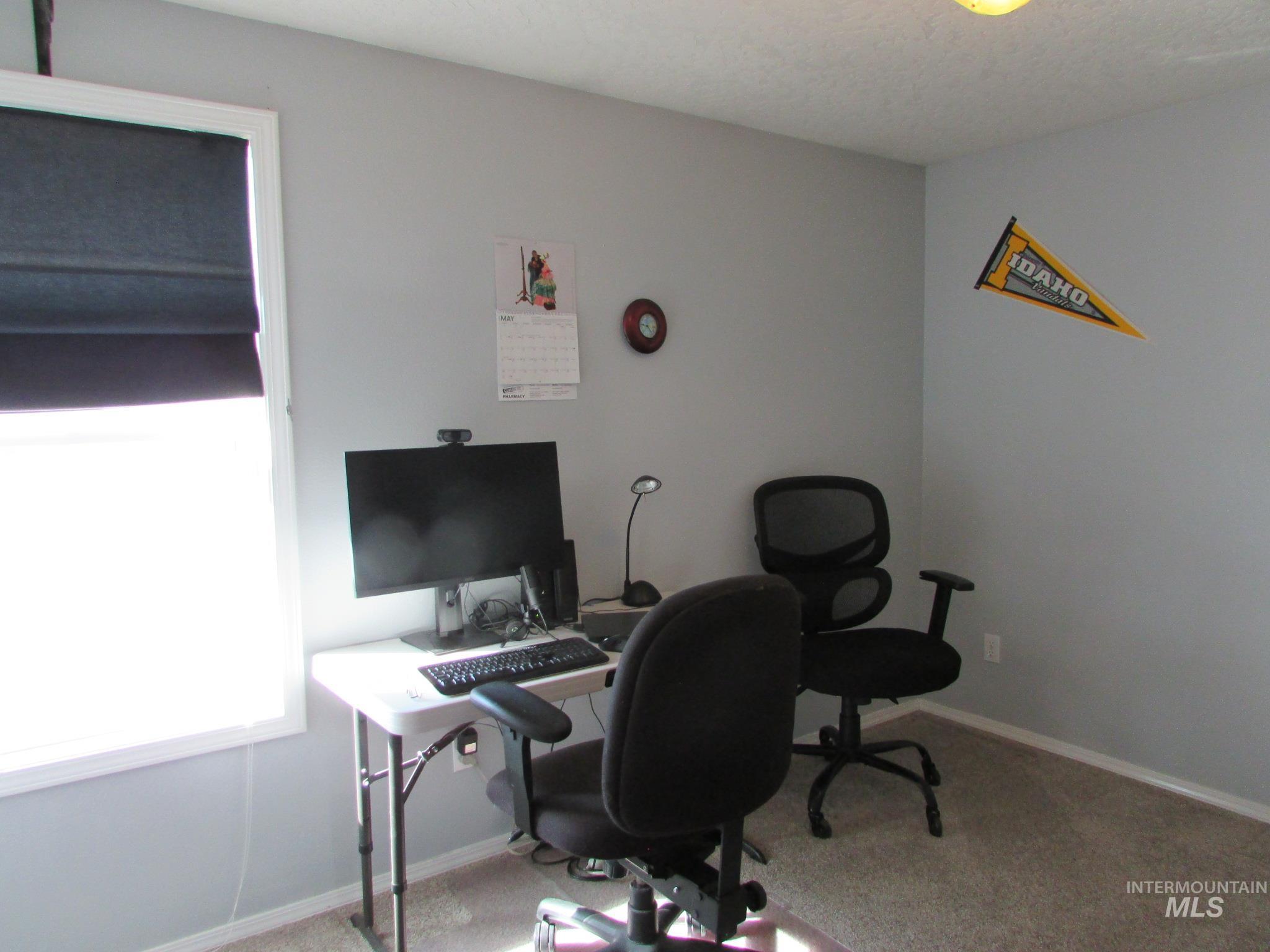 Room featuring light gray walls, white trim, and light beige carpeting
