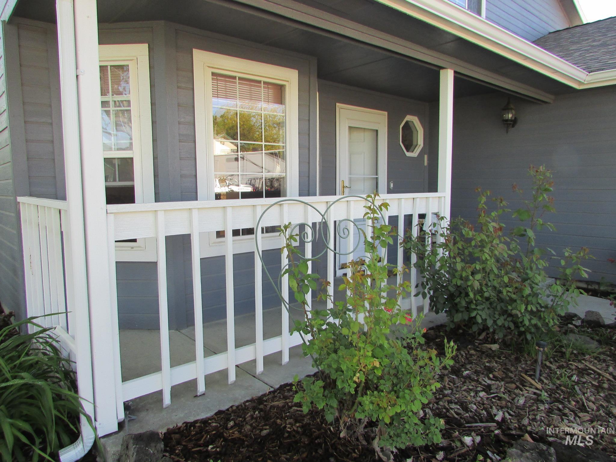 Inviting front porch with white railings and a prominent entryway