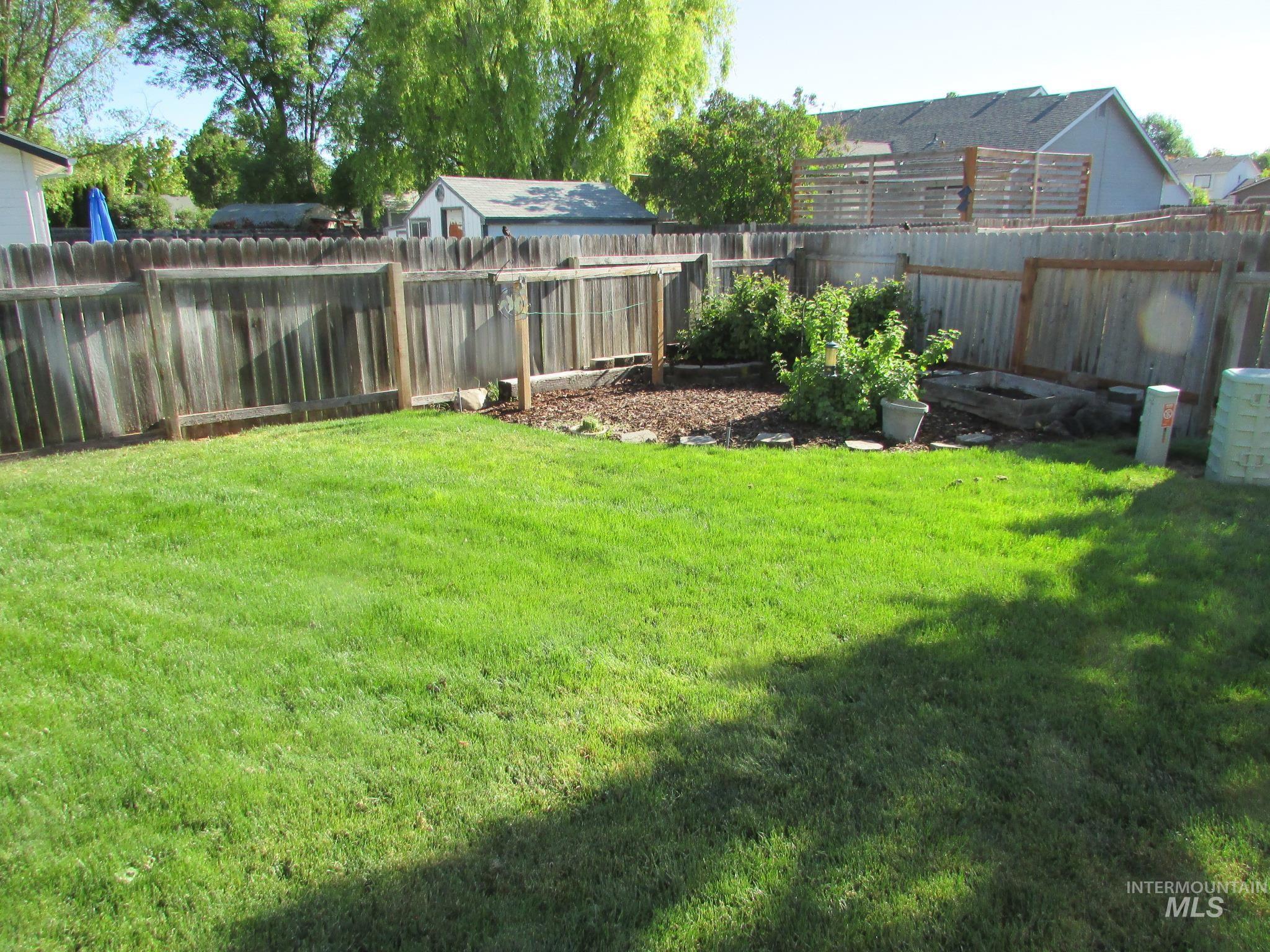 Expansive green lawn with established fencing