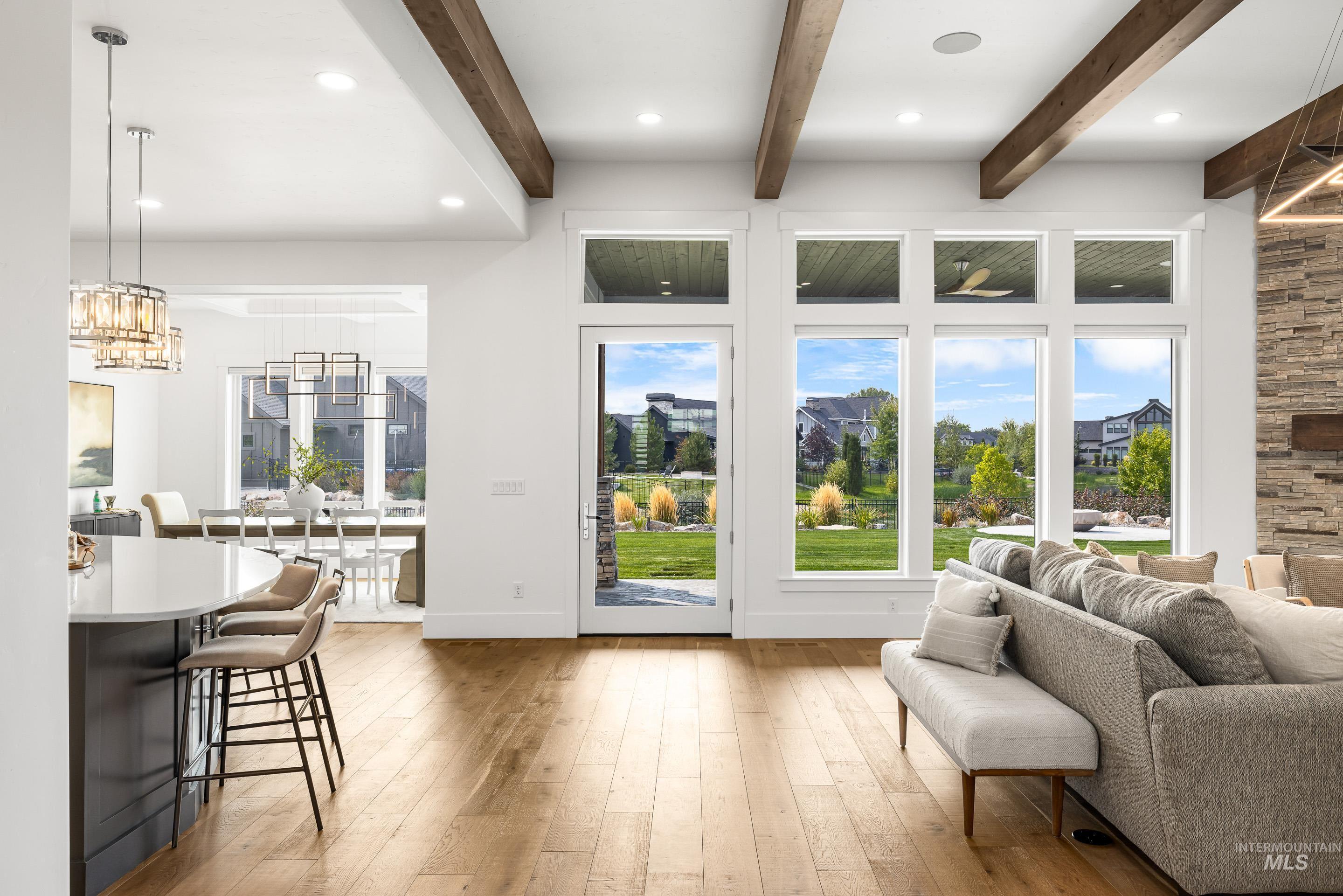 Doorway featuring hardwood / wood-style flooring, recessed lighting, a chandelier, and beamed ceiling