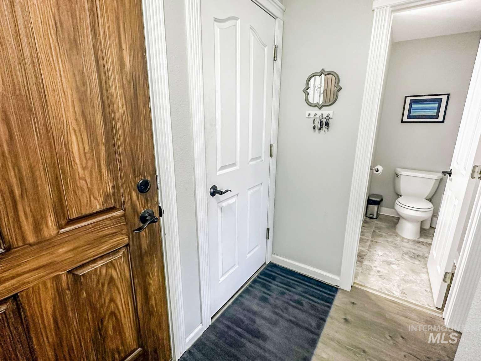 Bathroom with toilet and dark wood finished floors