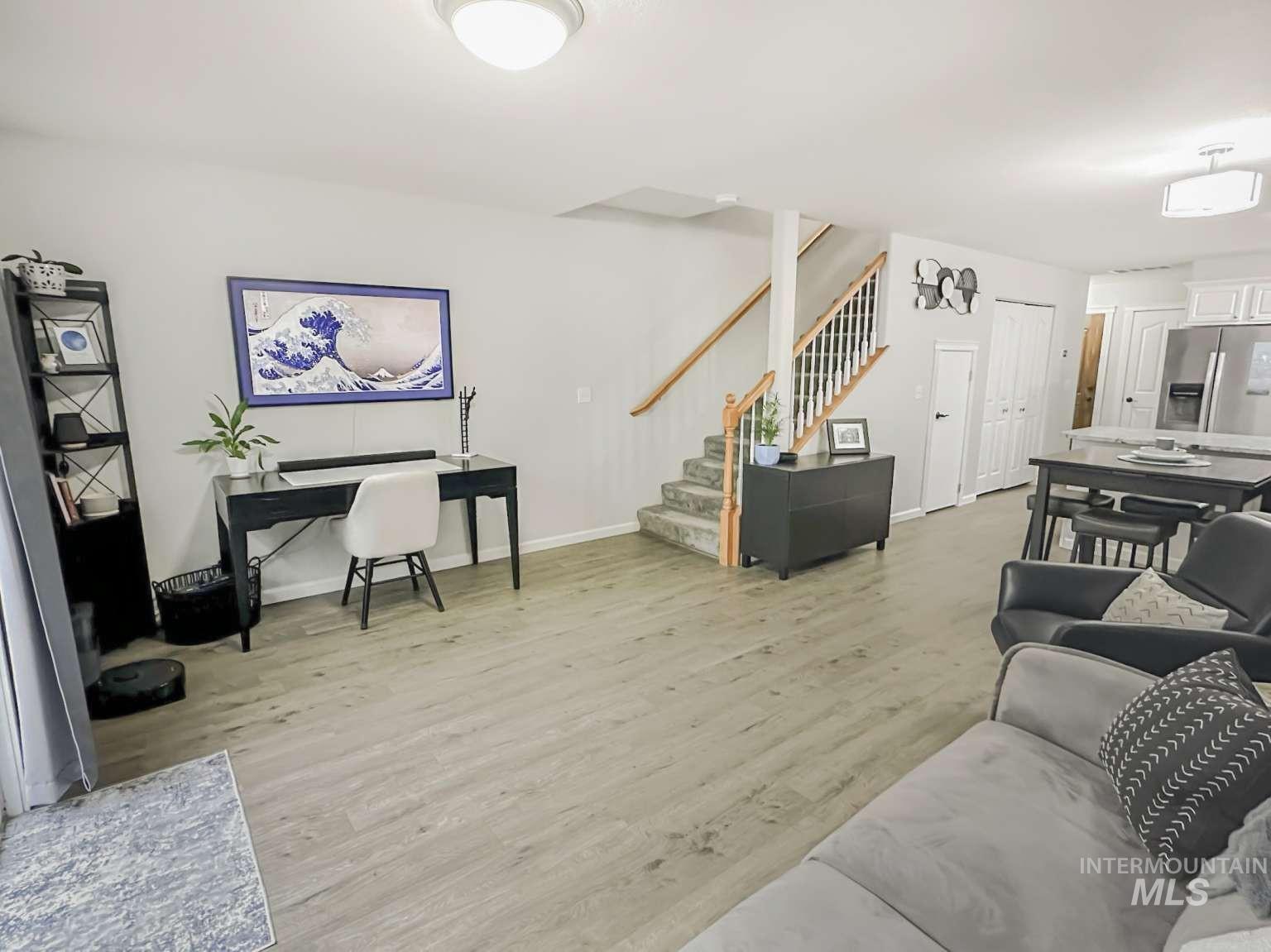 Living area featuring light wood-style flooring and stairway