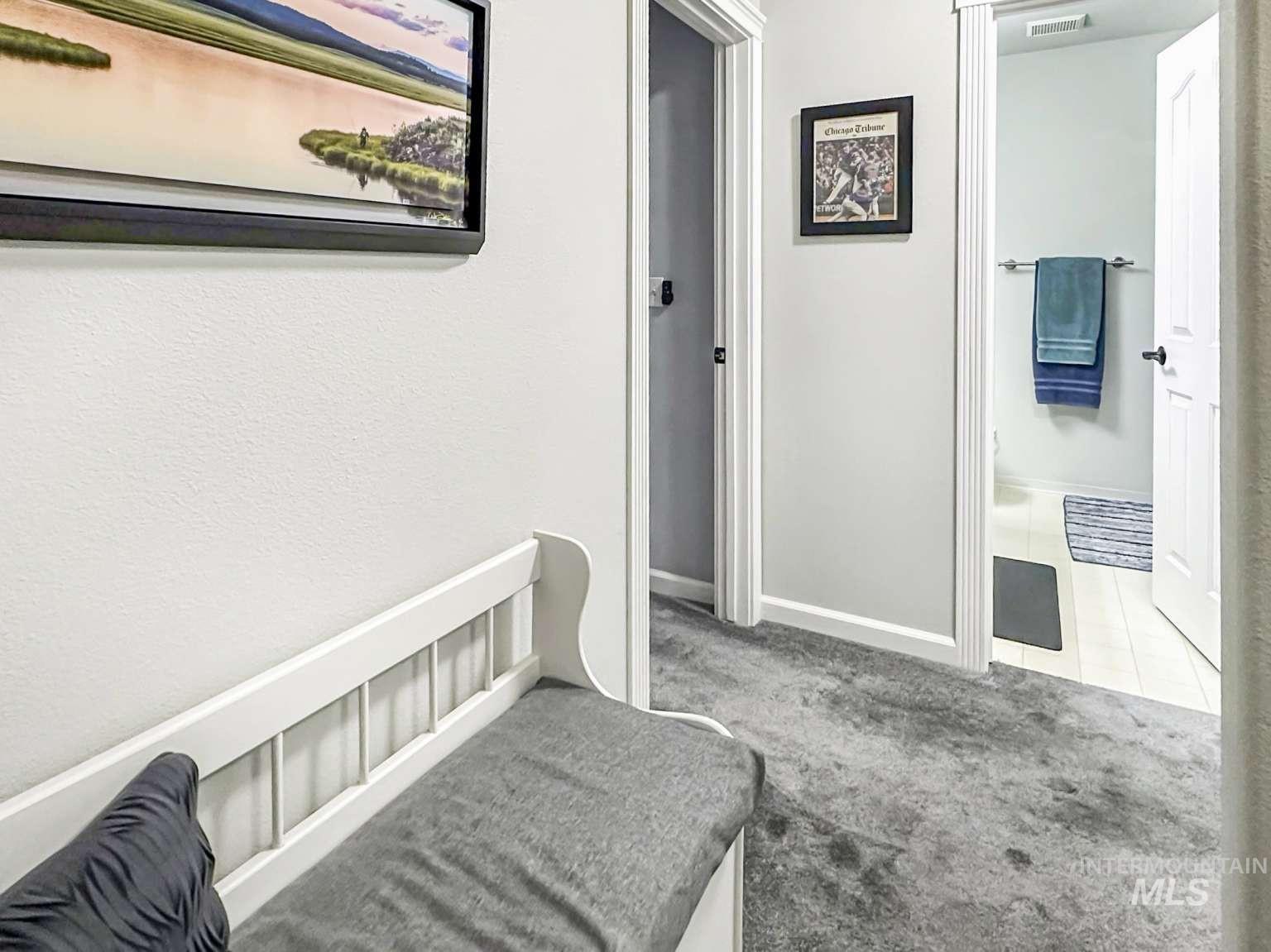 Hall featuring carpet and baseboards