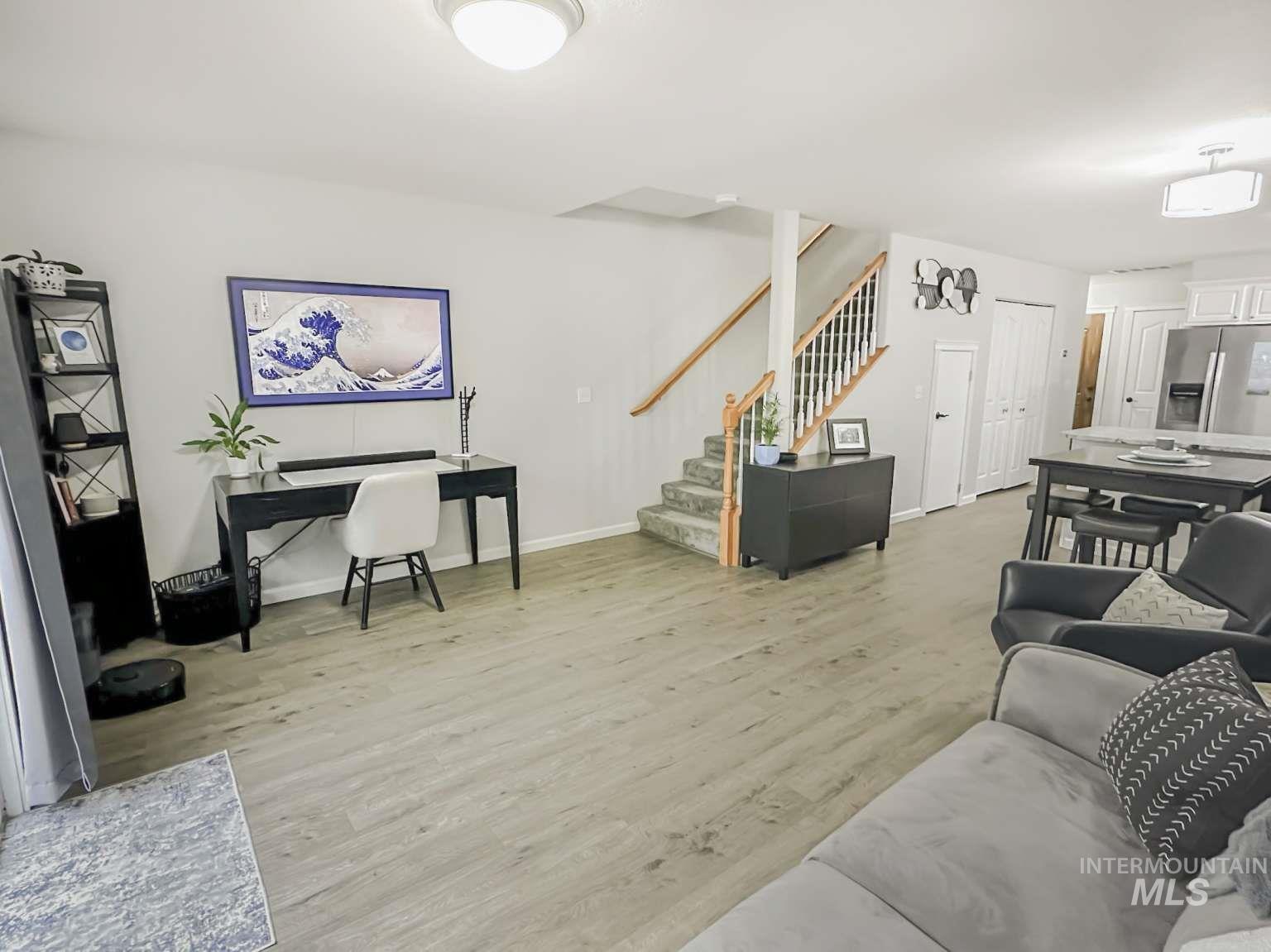 Living area featuring light wood finished floors and stairway