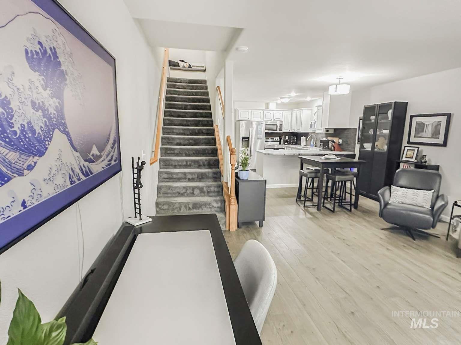 Living area featuring stairs and light wood-type flooring