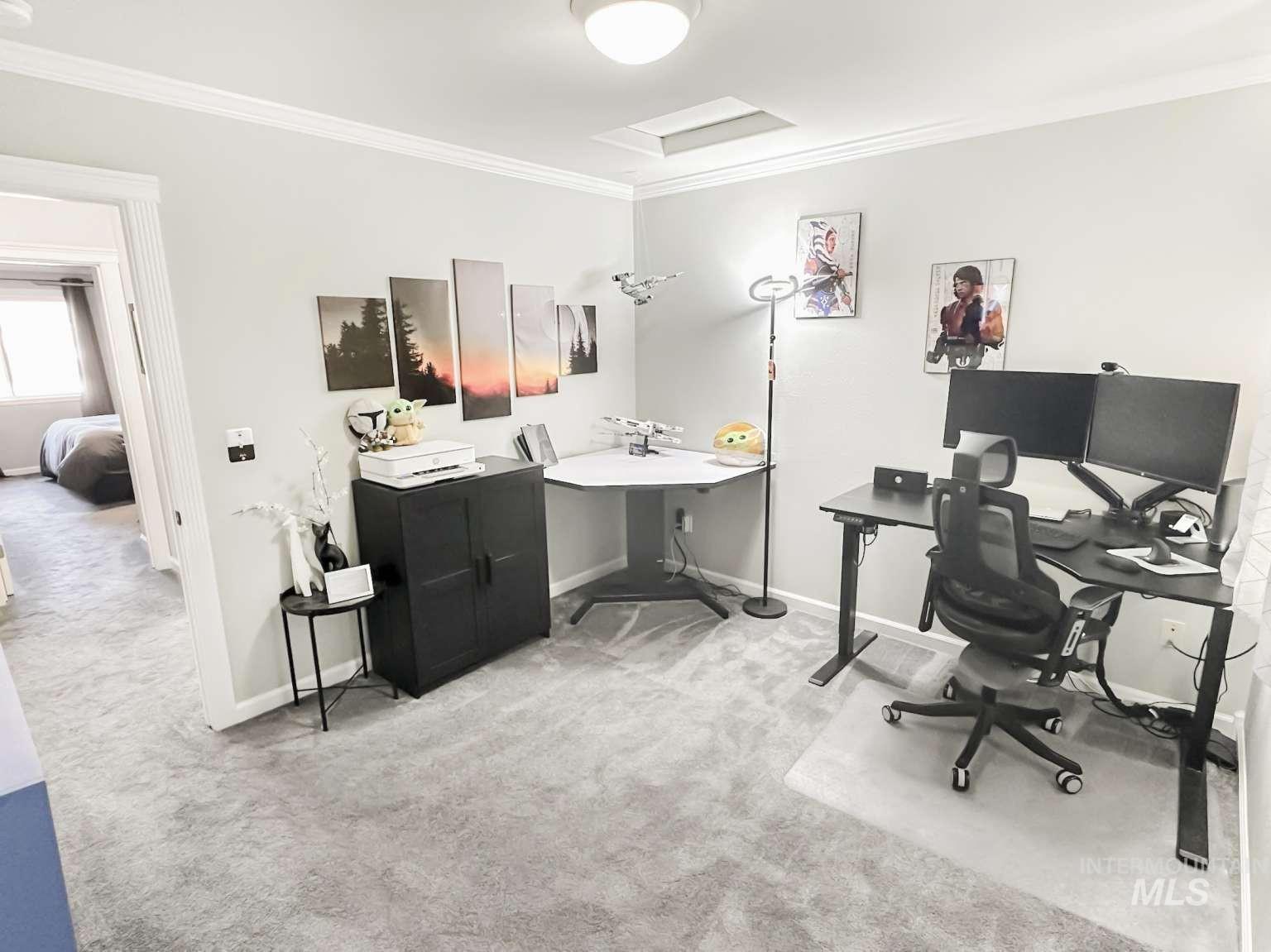 Office space featuring ornamental molding, light carpet, and attic access