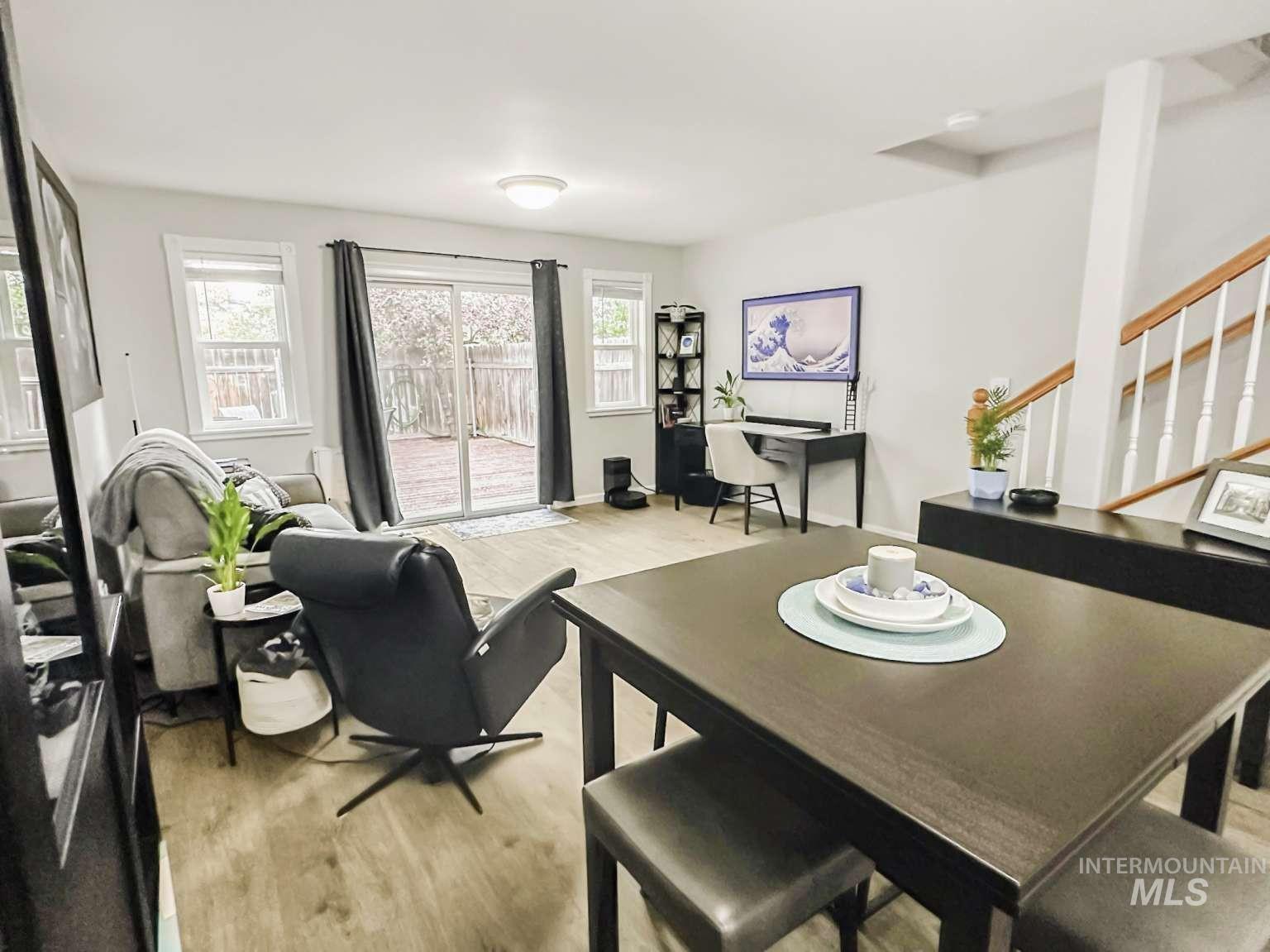 Dining area featuring light wood finished floors, stairway, and an office area