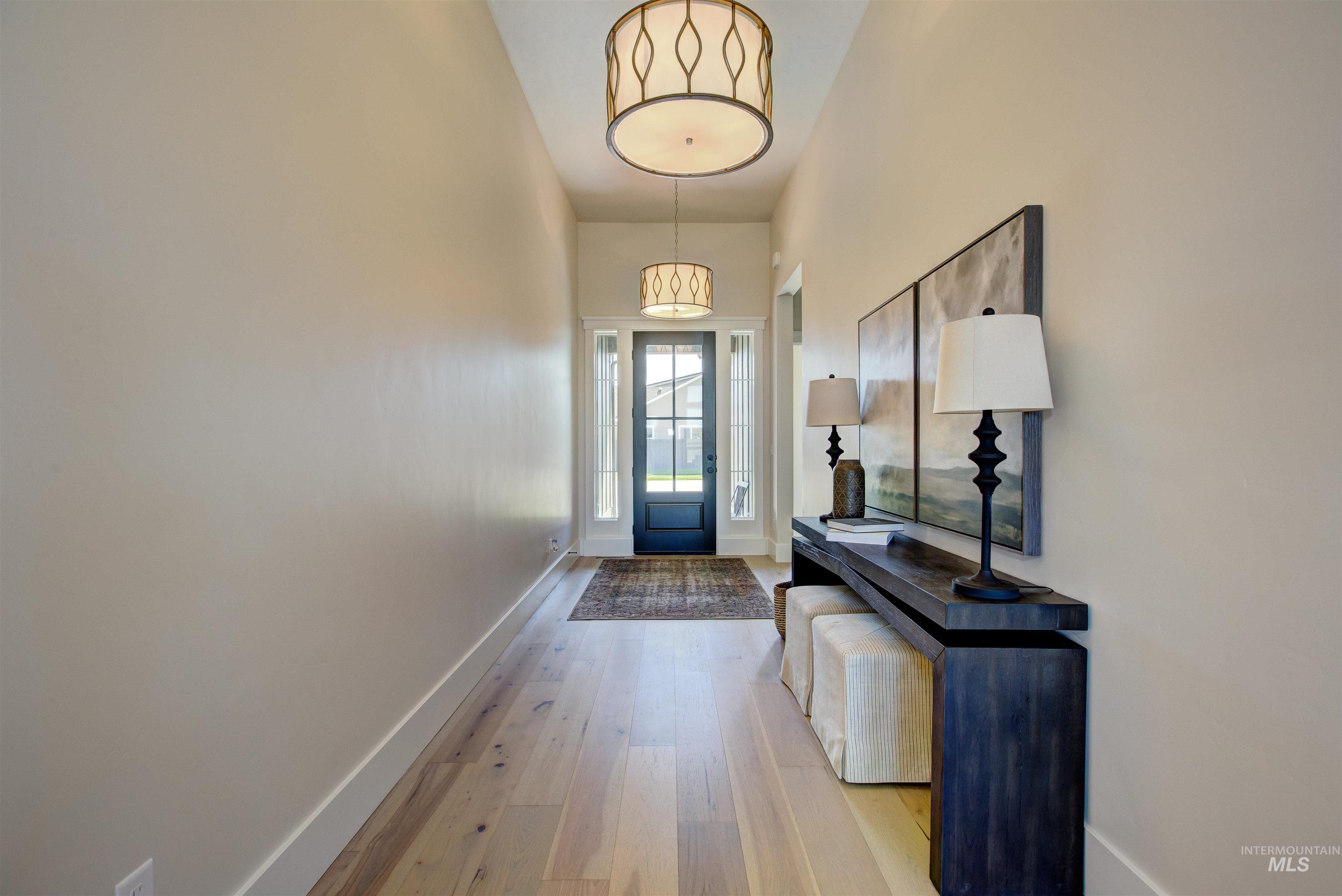 Entryway with light wood-style flooring and a high ceiling
