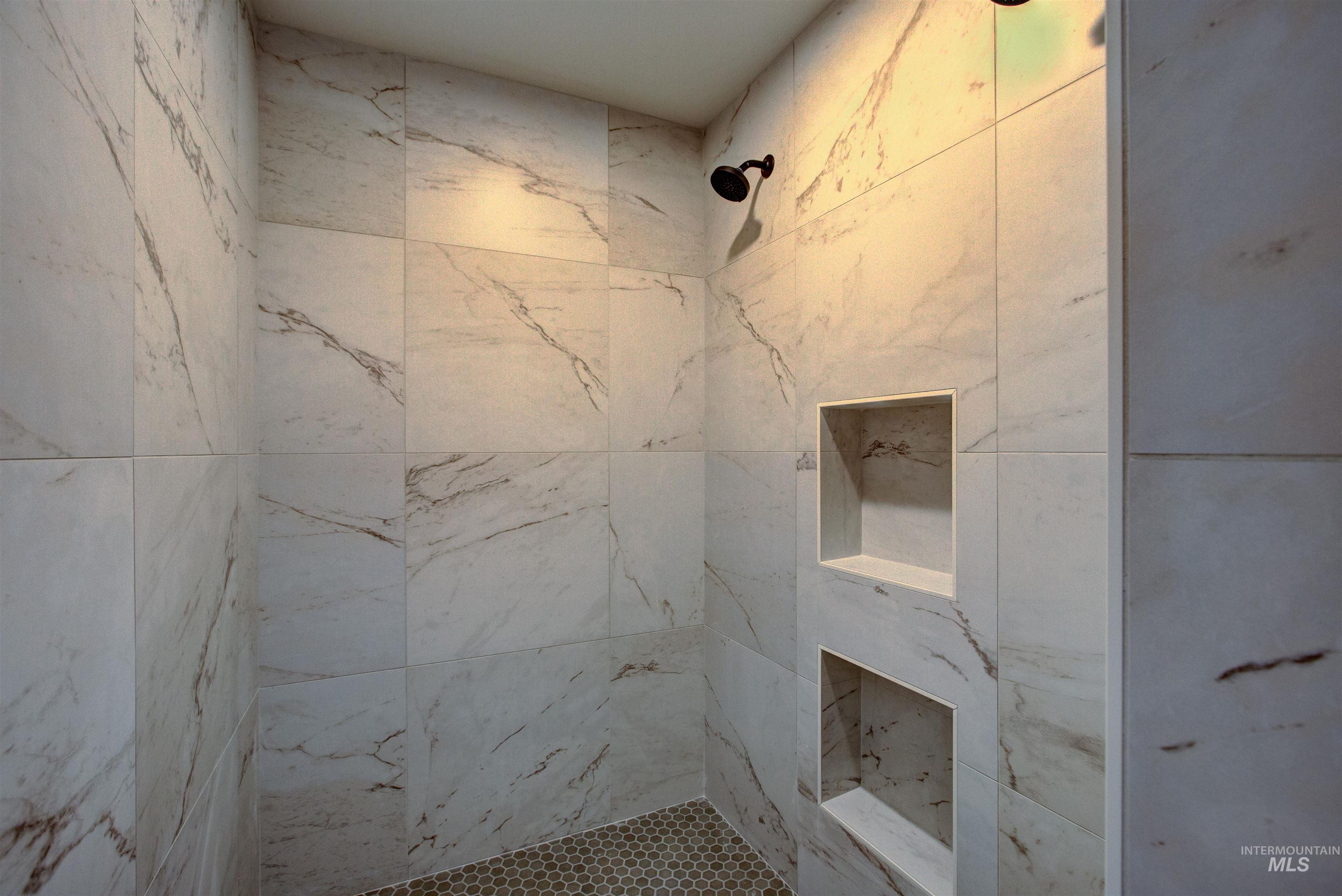 Full bathroom featuring a tile shower