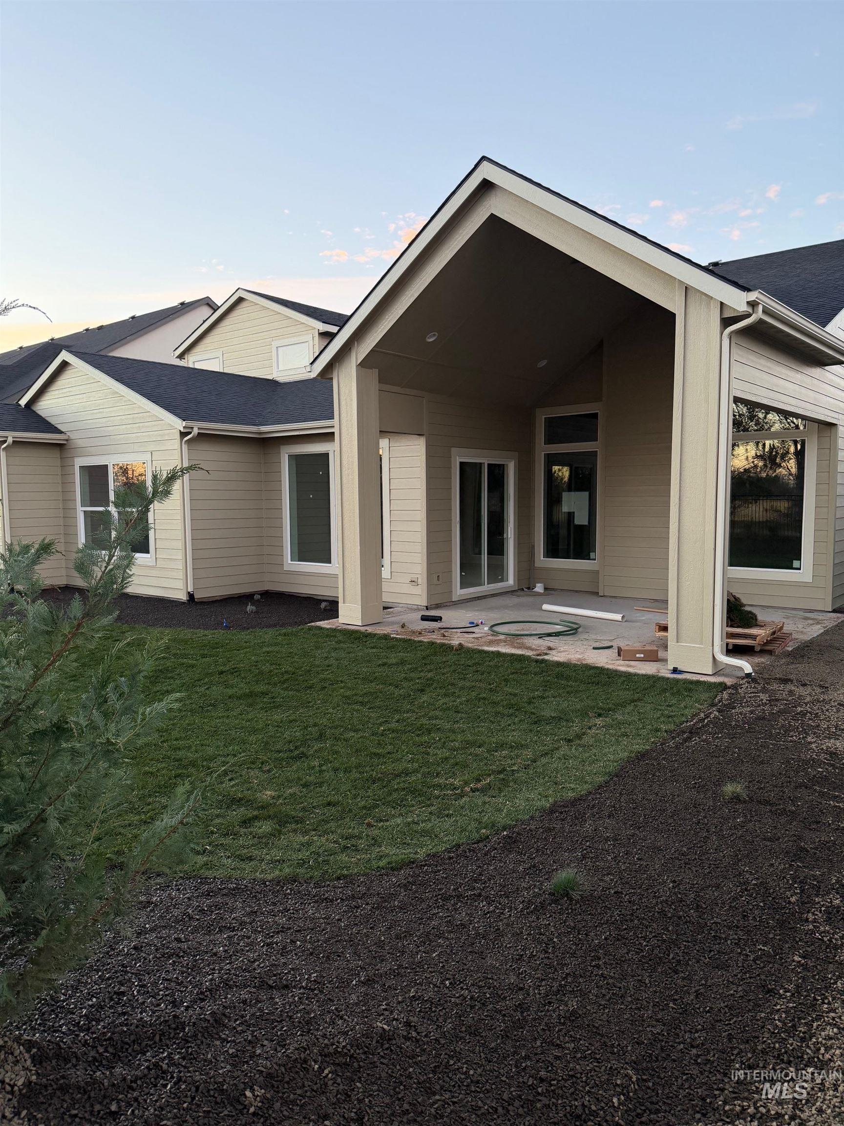 Back of house featuring a patio area and a lawn