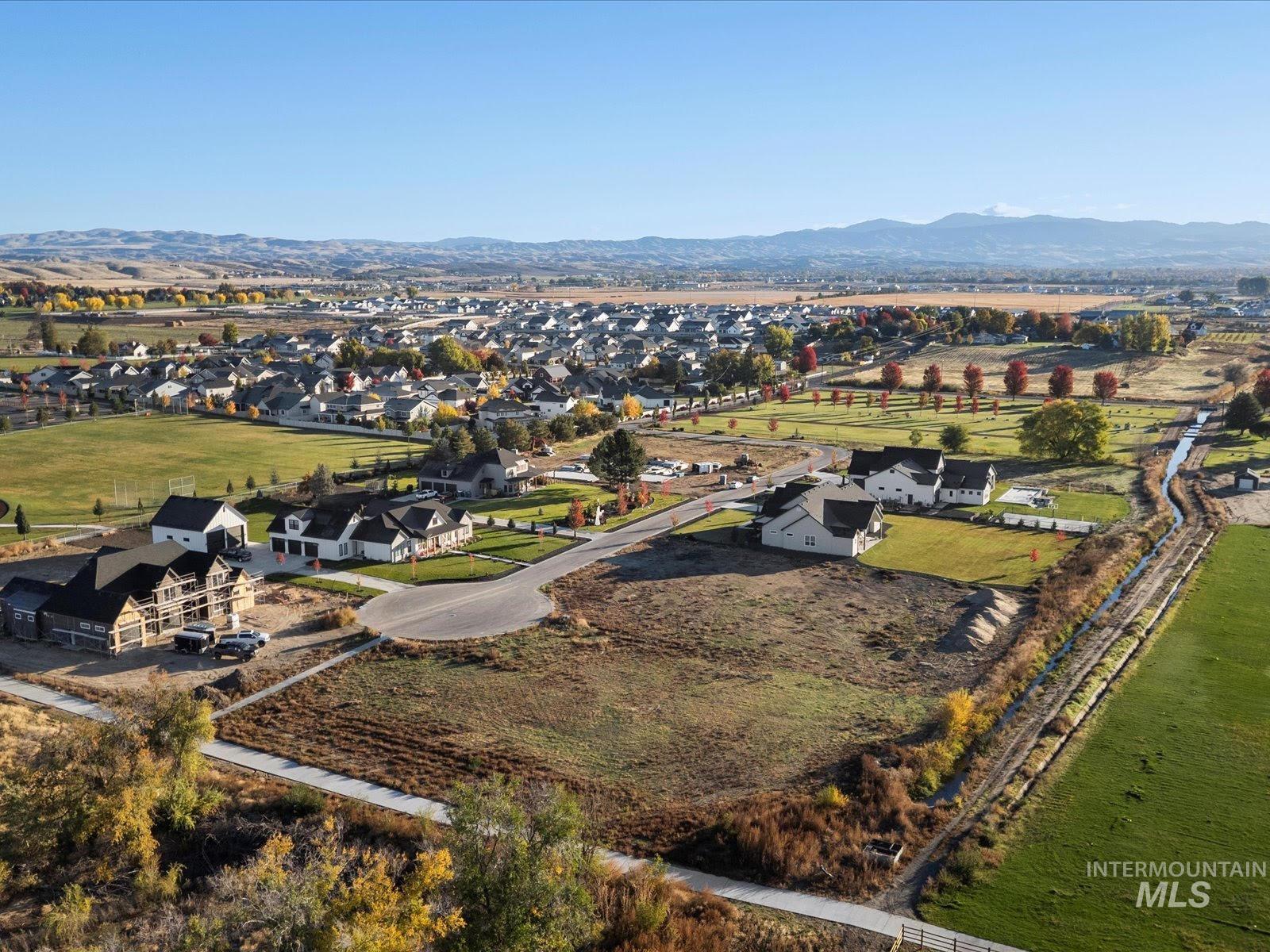 Aerial overview of property's location featuring mountains and nearby suburban area